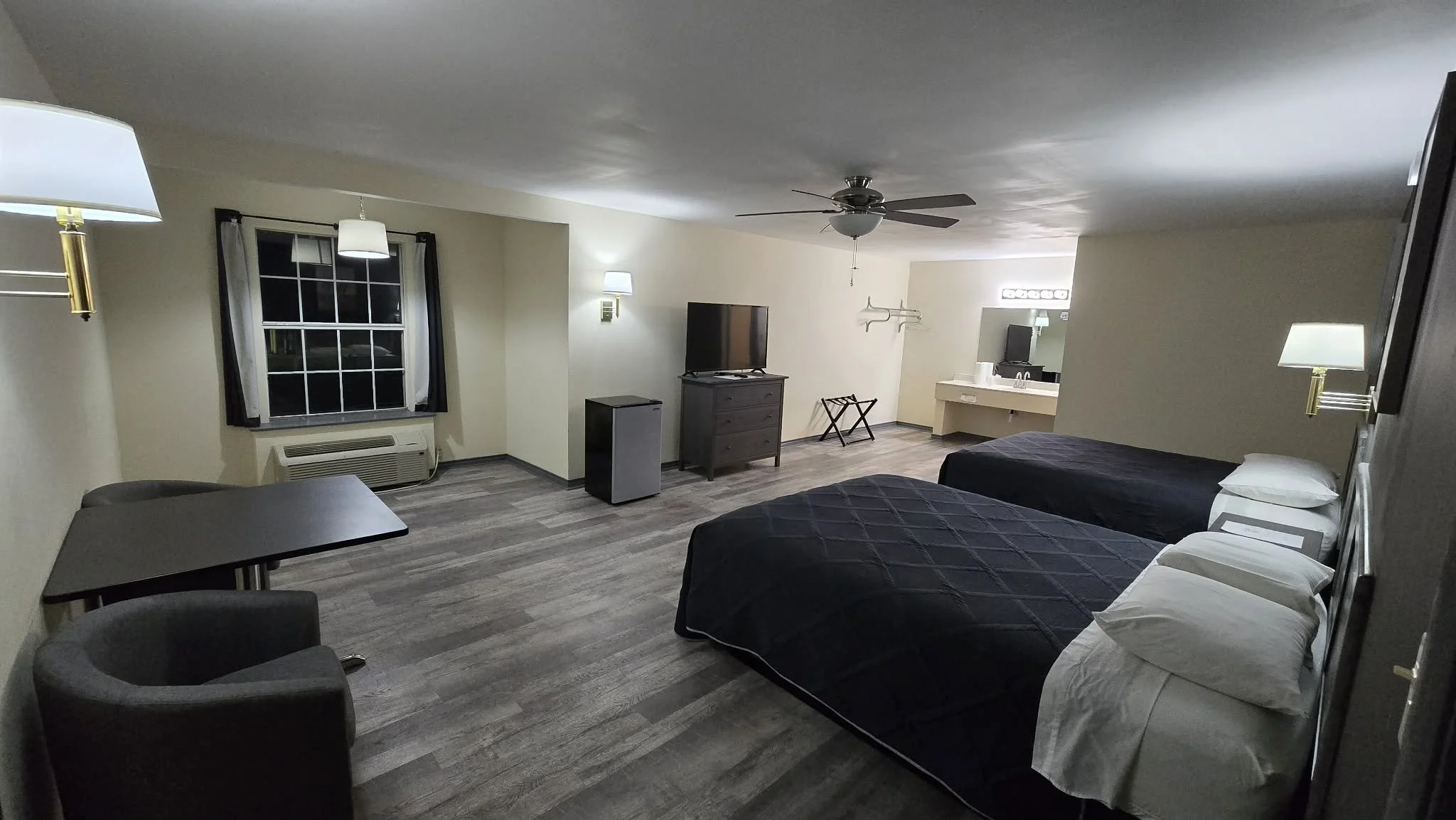 Picture of Swiss Lodge Motel room interior. Shown are two queen size beds in a large clean room with hardwood flooring.