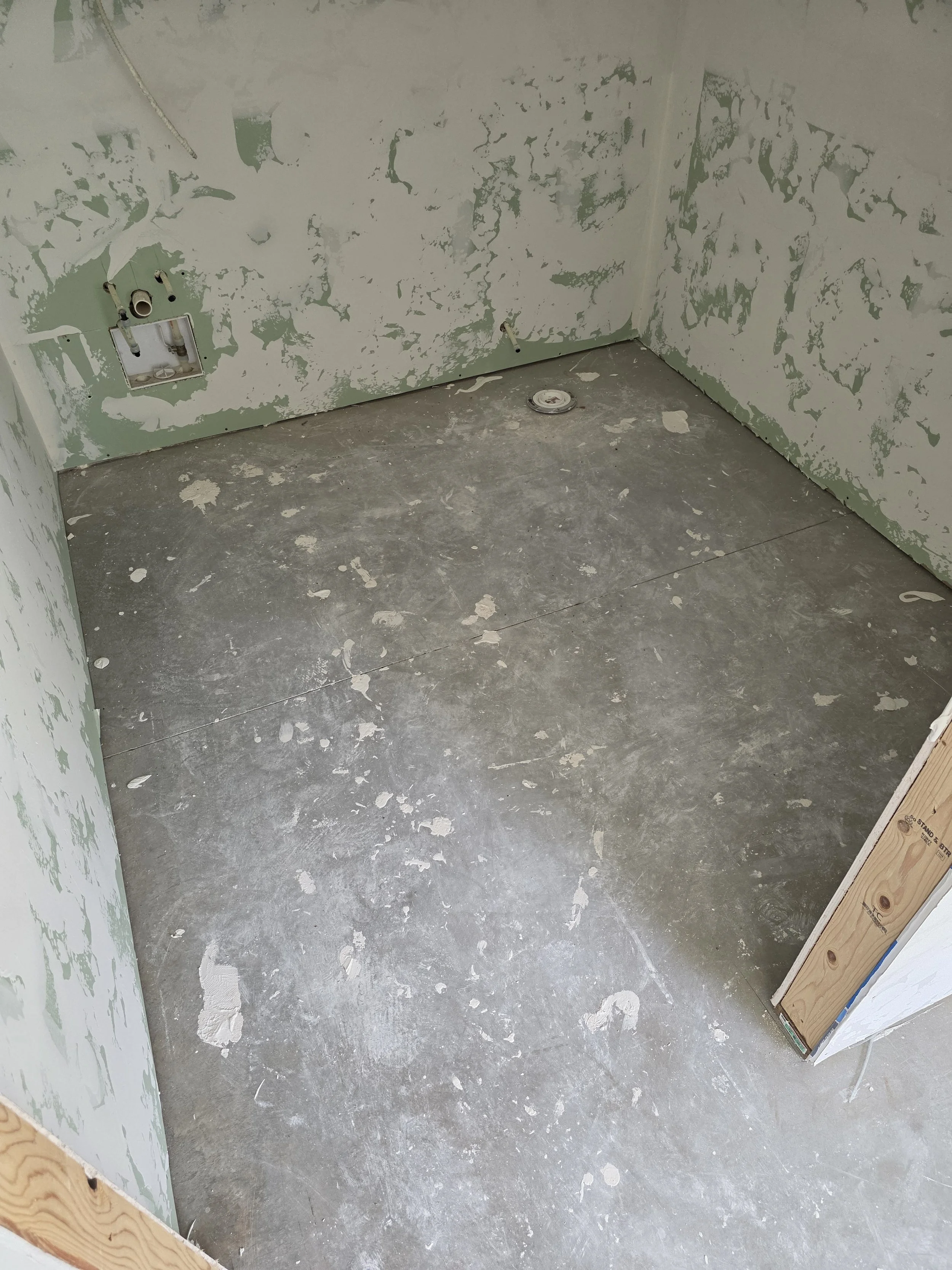 All of the spots of debris will be removed upon grinding the floor.