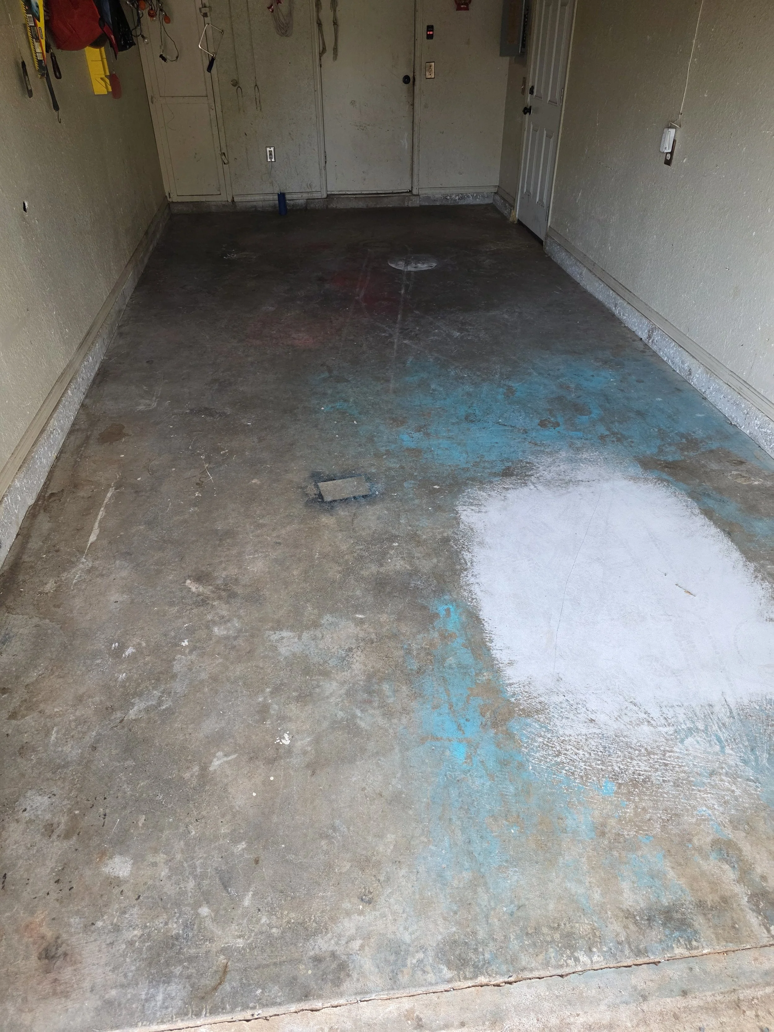 Another angle of the existing slab before any work begins. Staining and contamination are visible across the full floor — exactly why proper prep is non-negotiable.
