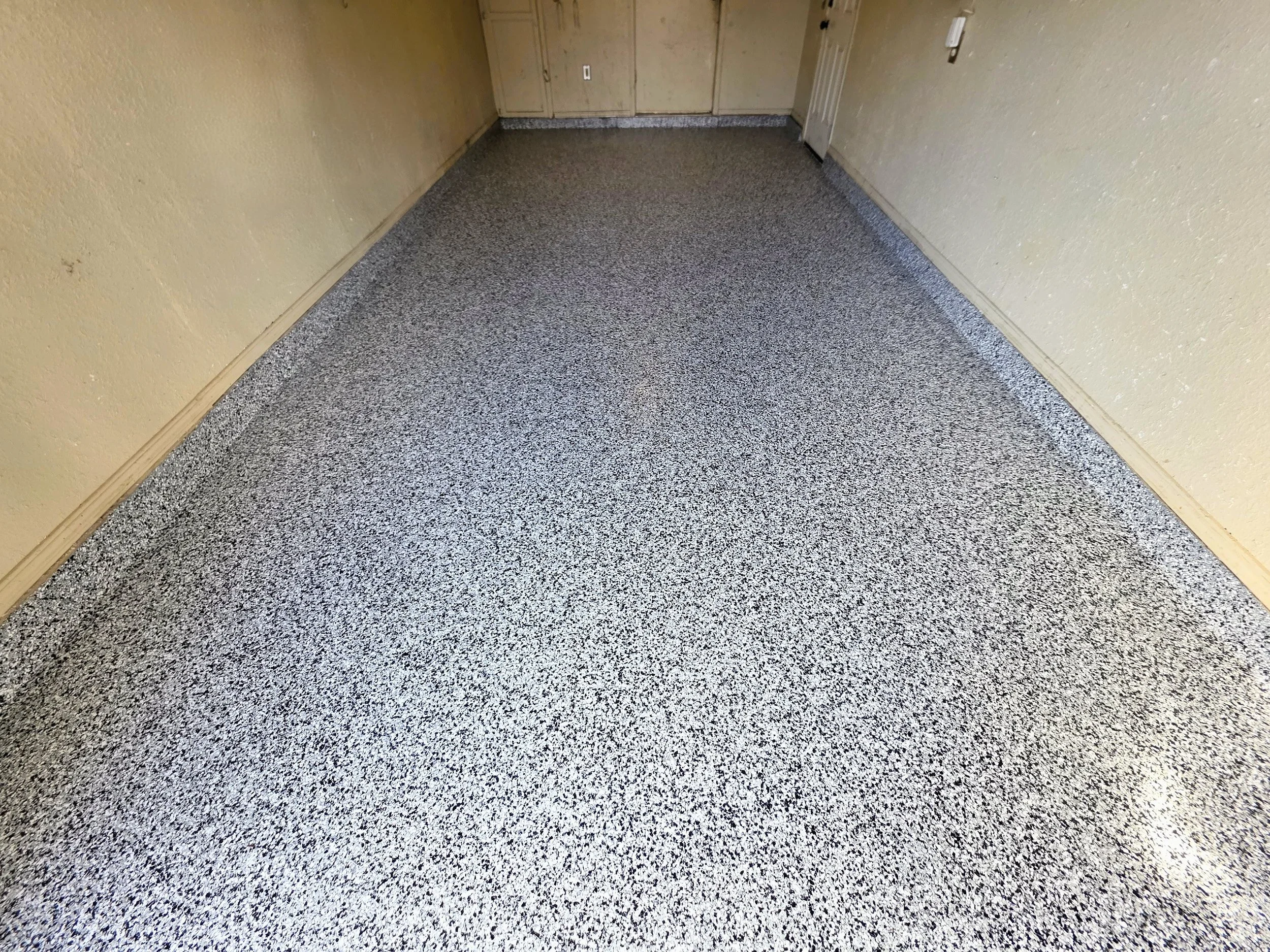 Polyaspartic topcoat applied and cured. The finished floor is sealed, protected, and ready for years of use.