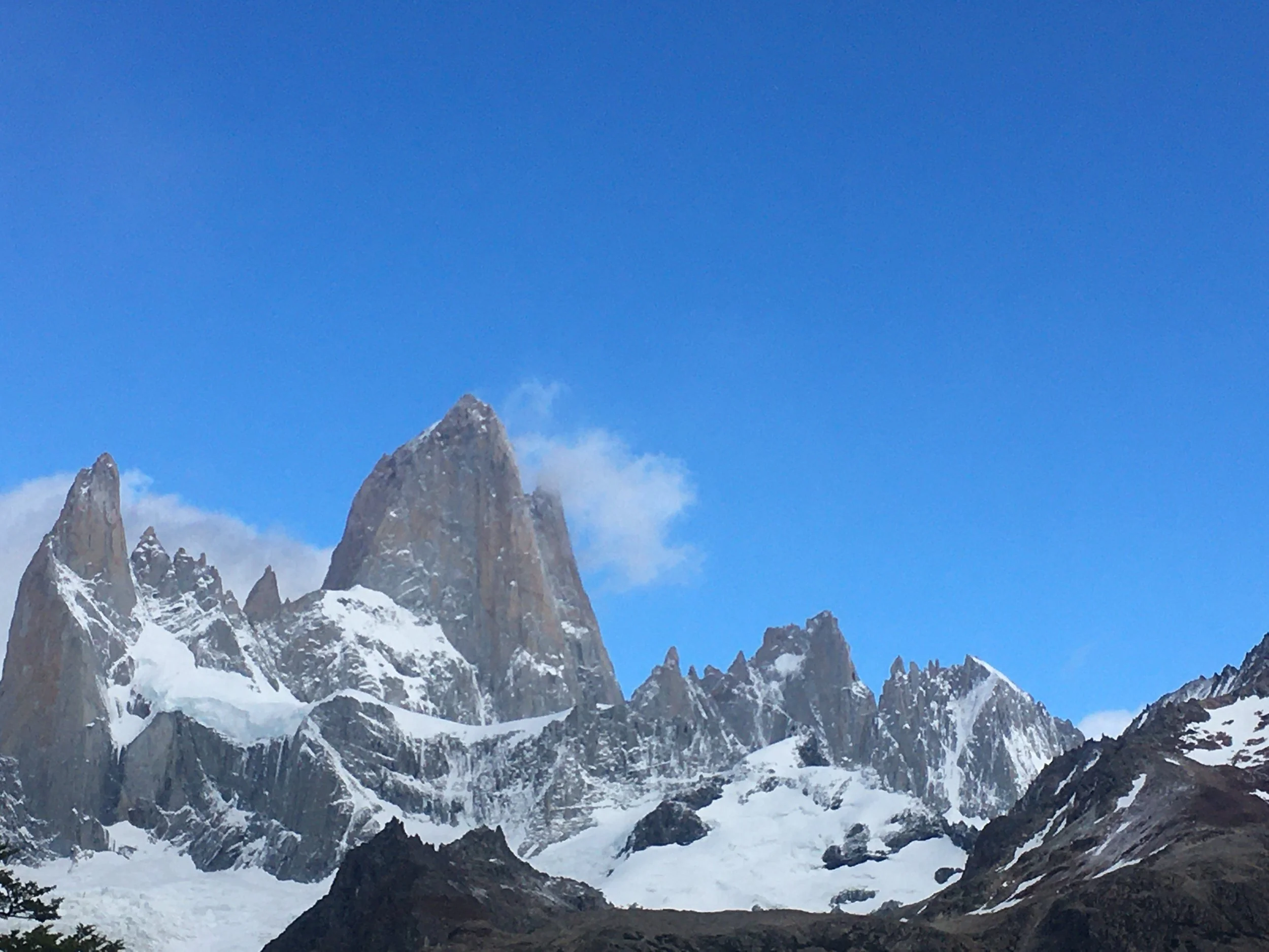 Snow-capped mountain peaks under a clear blue sky.