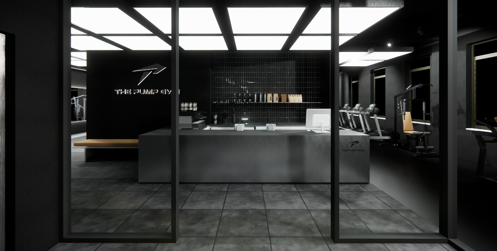 Modern gym reception area with black walls, a desk with Apple computers, workout equipment in the background, and large windows.