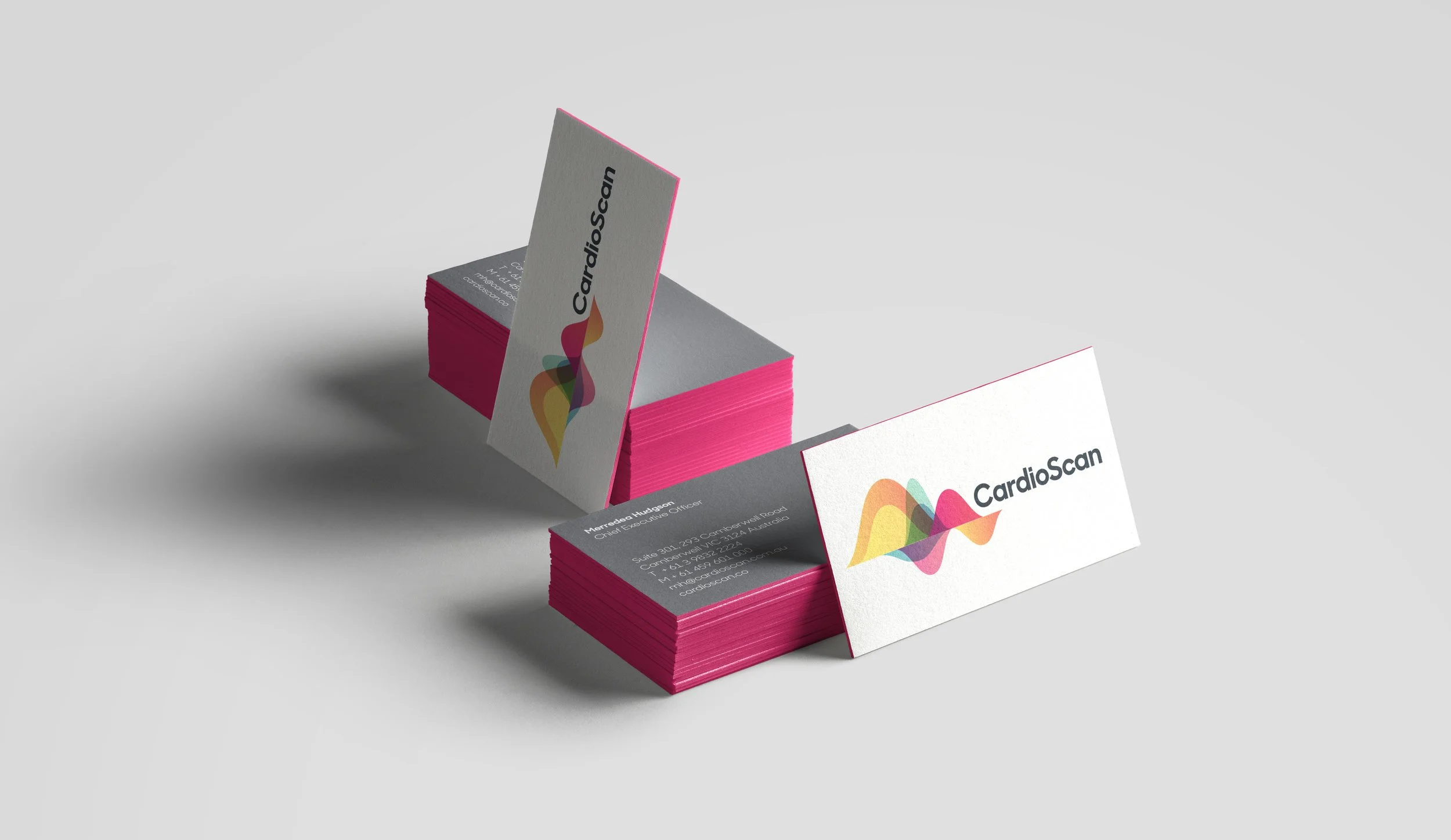 Business cards for CardioScan with a colorful wave logo on a light background.