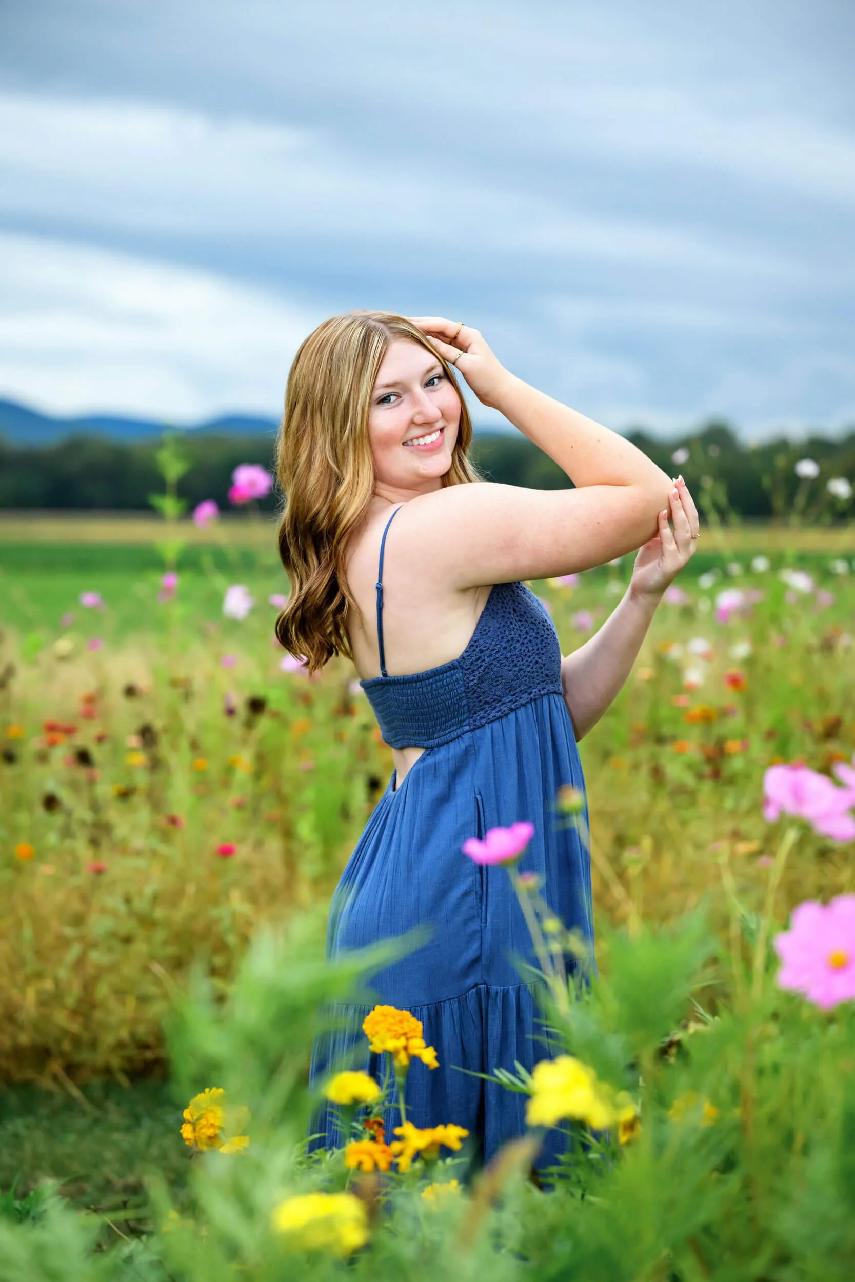 Young woman in a blue dress in a wildflower field.jpg