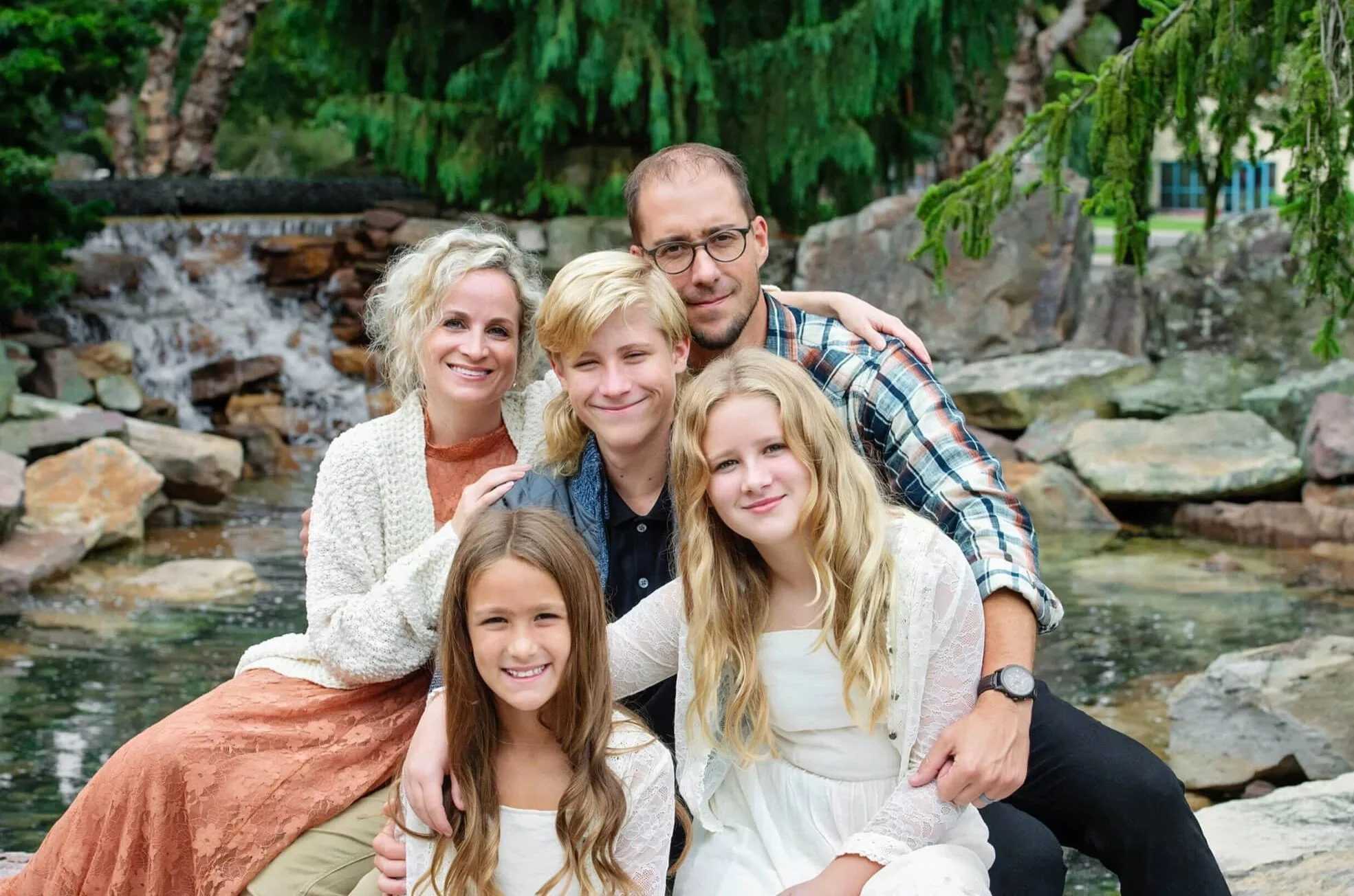 family photo with mom dad brother and two sisters sitting close for family portrait session Williamsport Pa
