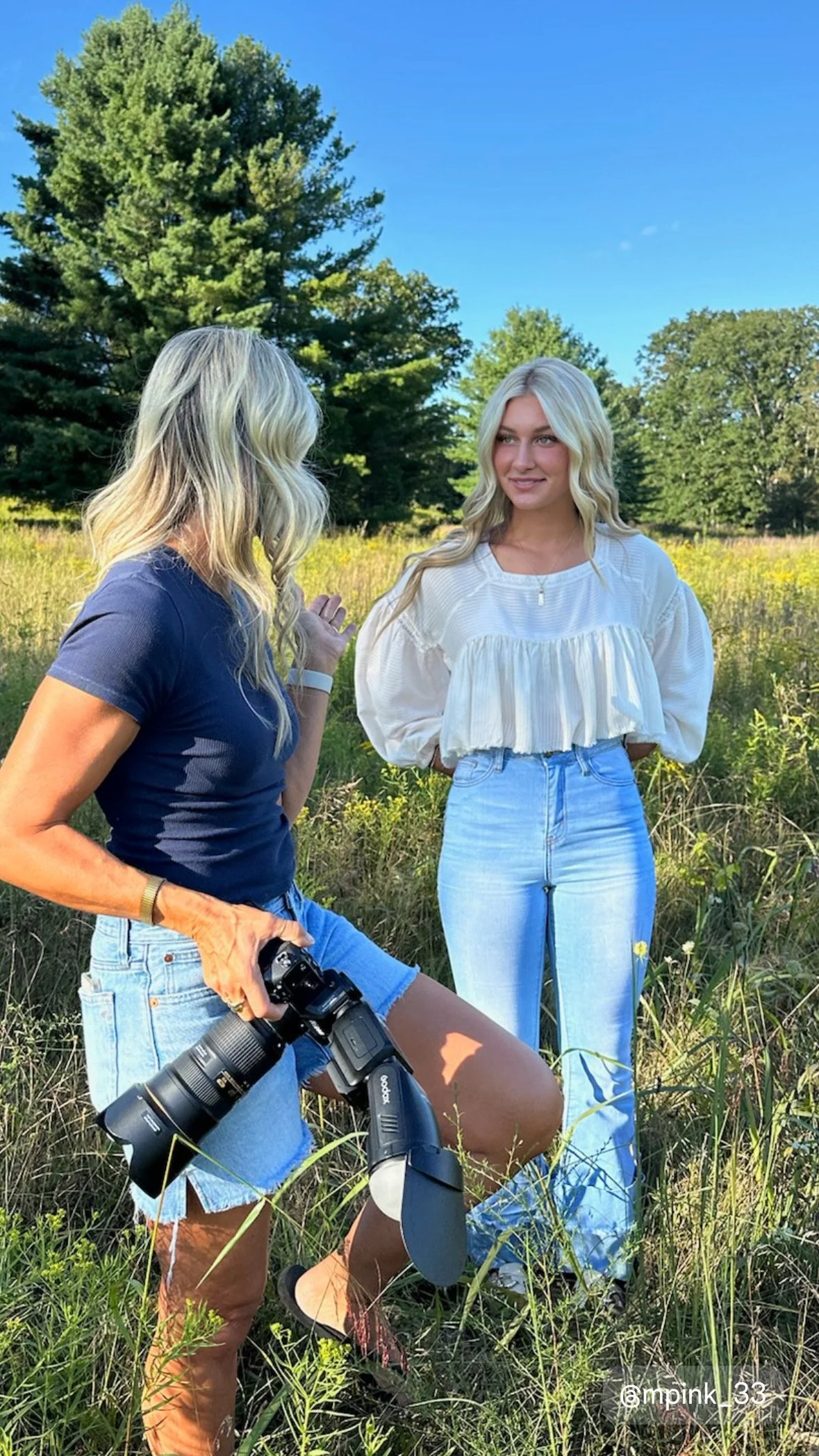 Behind the scenes of high school senior photo session at Rider Park Montoursville PA helping senior girl pose for photo 