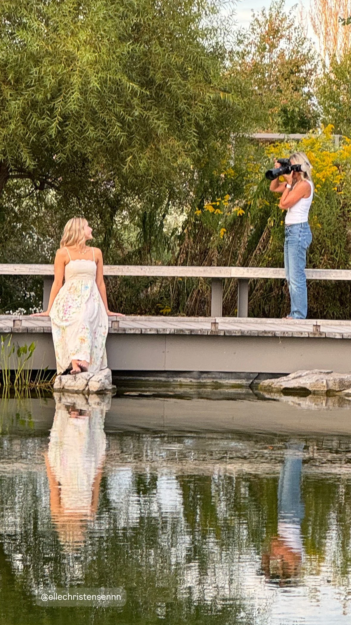 Tish OConnor Photography behind the scenes photo of Tish taking pic of senior girl in long dress sitting on bridge at Penn State Arboretum