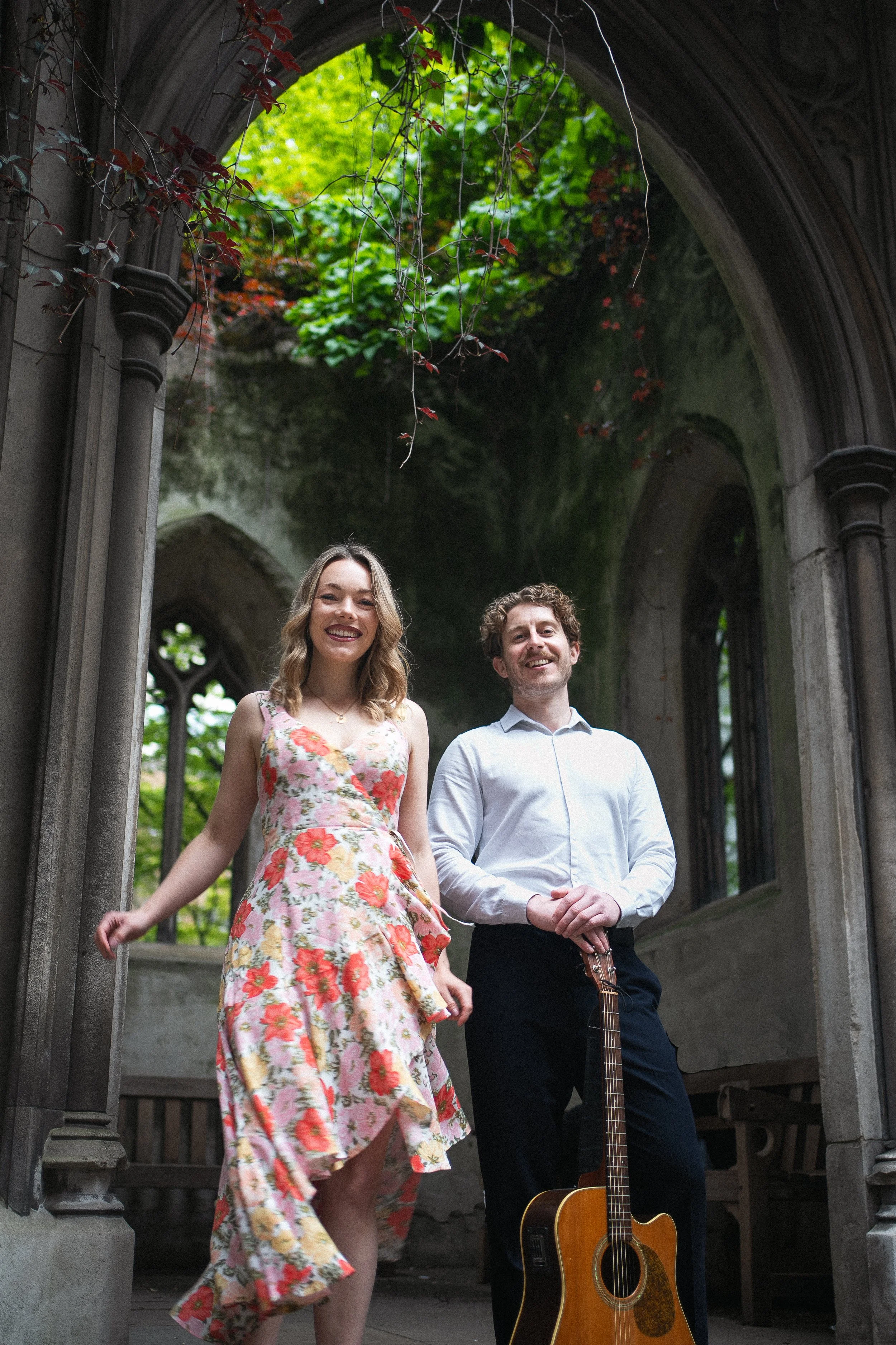 Acoustic wedding duo with an acoustic guitarist and a vocalist performing at a London venue for a summer wedding