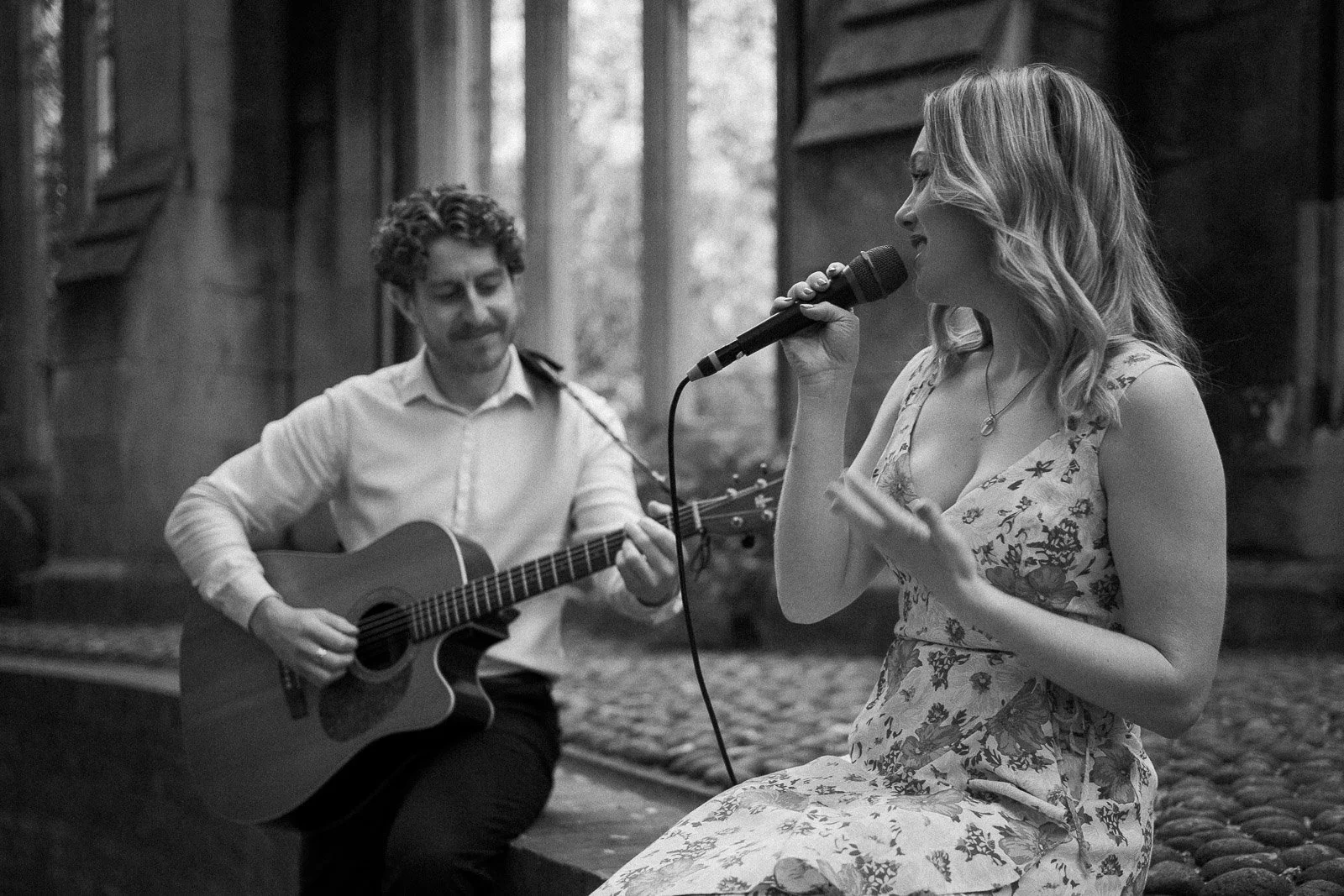live guitar and vocal duo performing acoustic music at a wedding event in the UK