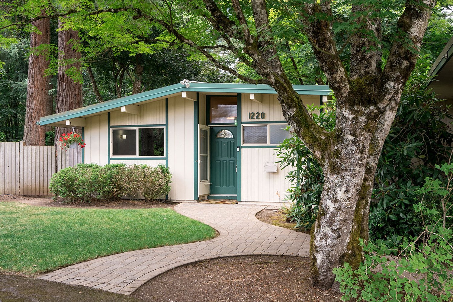 Real estate exterior photography showing residential property with landscaped front yard