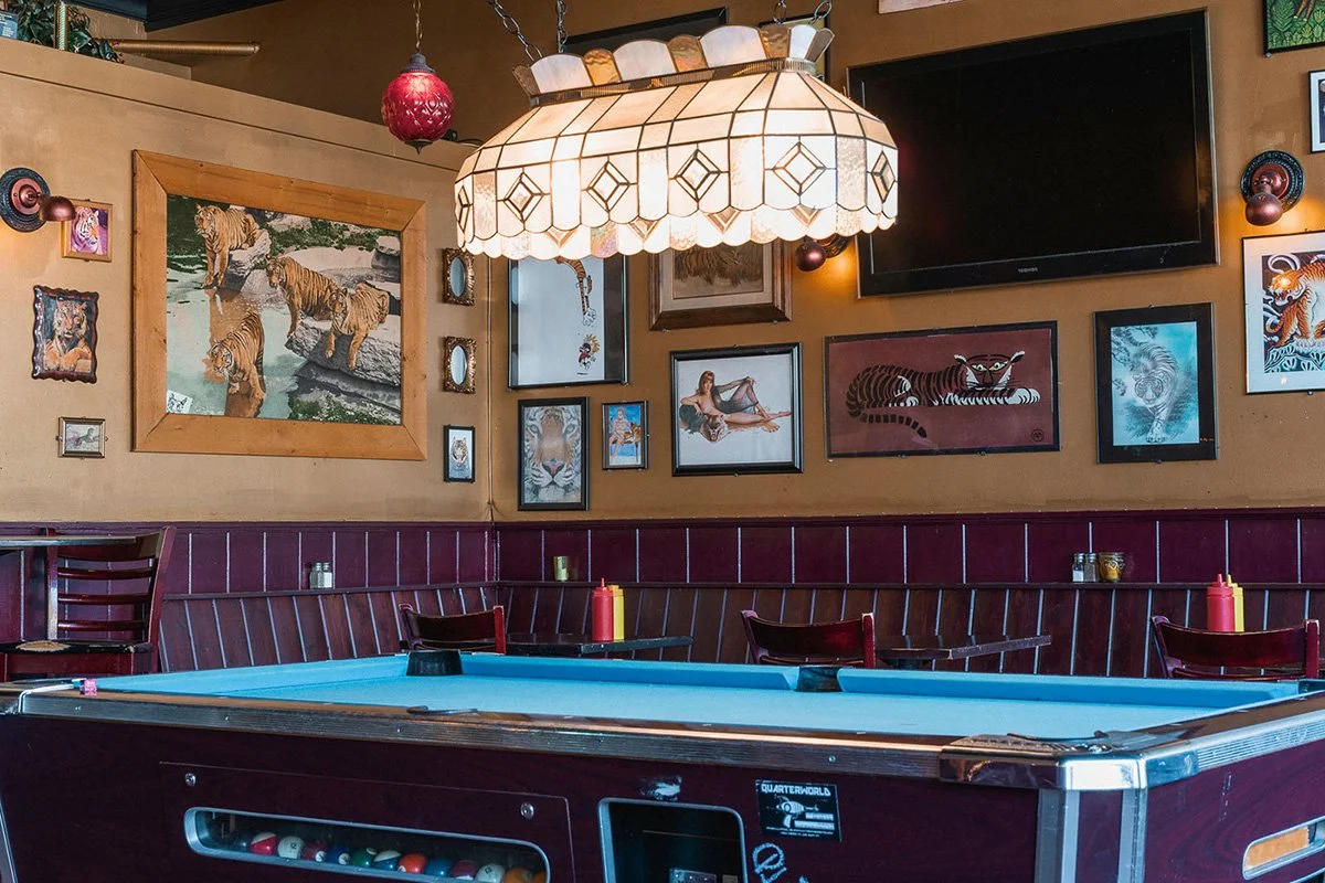 Hospitality interior photography showing pool table and bar seating