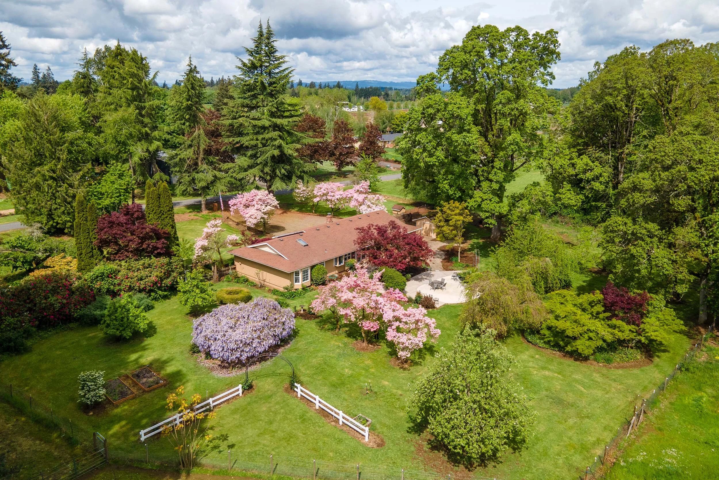 Drone aerial photography showing real estate property with spring landscaping and blooming trees