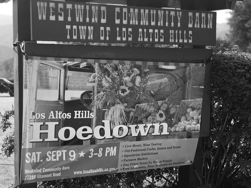 Black and white poster advertising the Westwind Community Barn event in Los Altos Hills, California, on Saturday, September 9, from 3 to 8 PM. It features live music, wine tasting, crafts, games, prizes, exhibitions, a farmers market, and a family ev