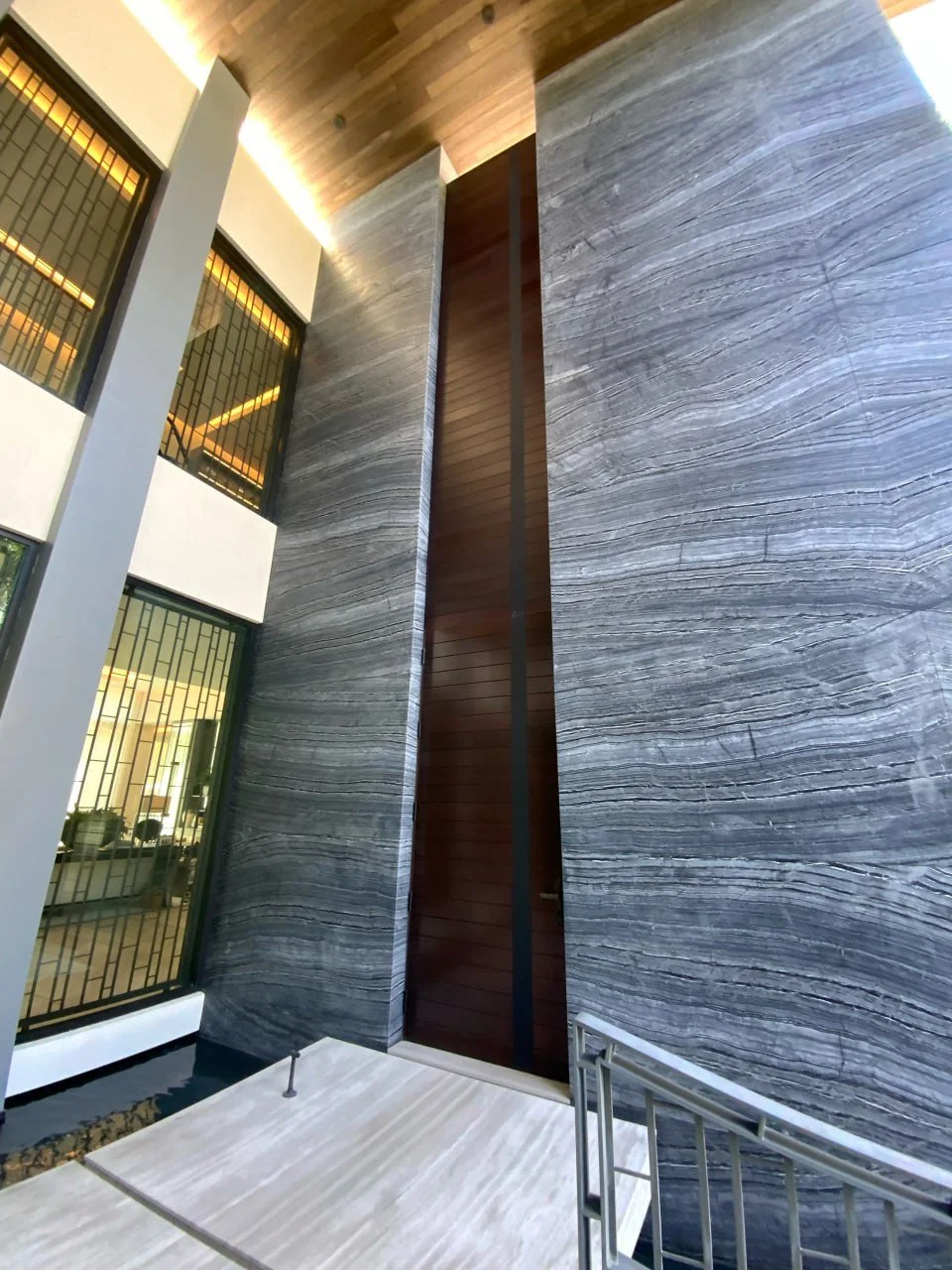 Finished stone and wood entry detail by CoreCraft Construction in South Florida