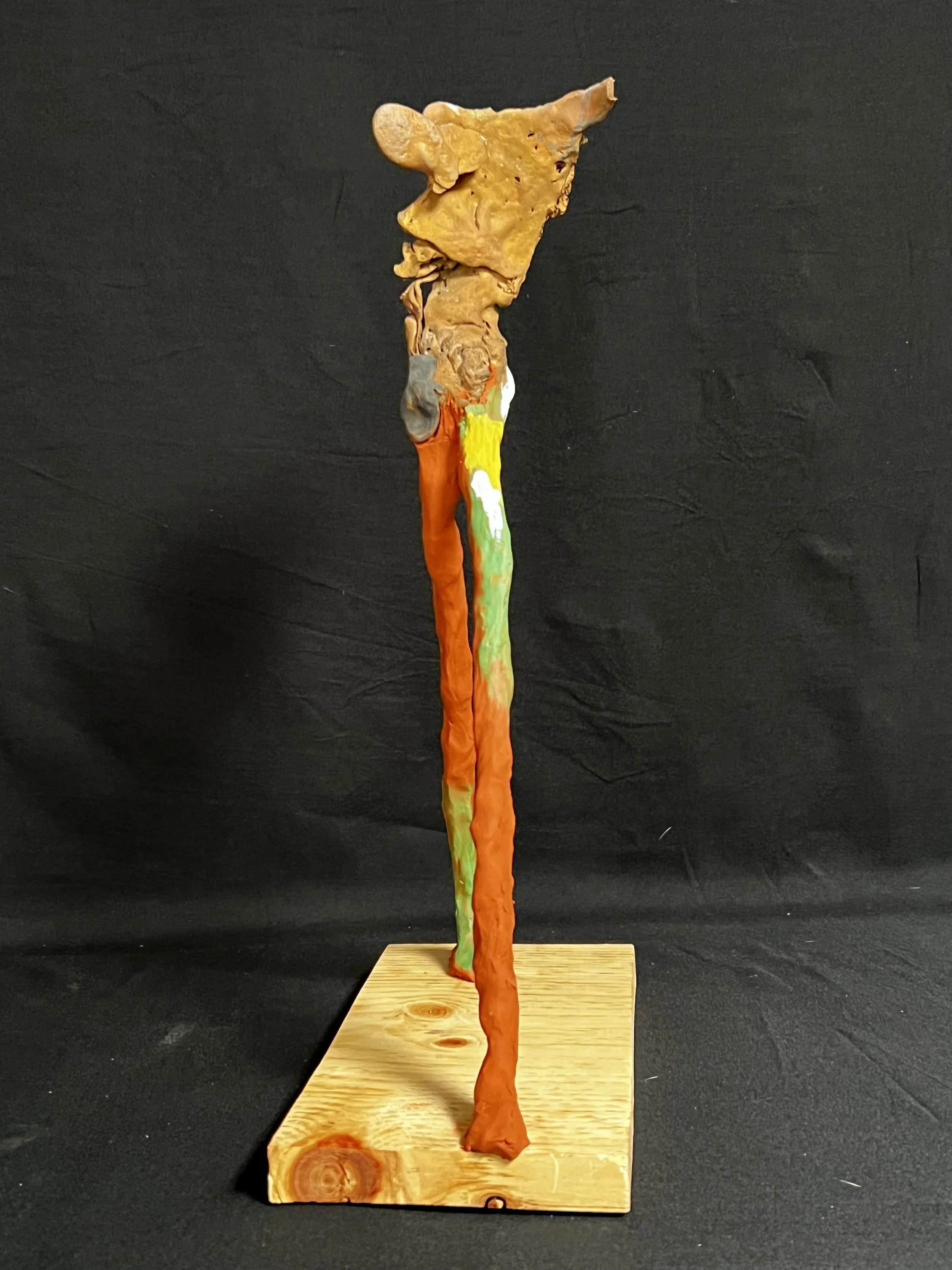 Figure Striding    17"x5"x11" Bronze, Polymer Clay, Paint, Wood      $2000.00