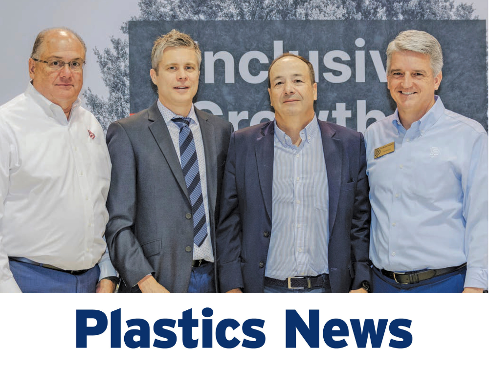 Four men in business attire standing together at a Plastics News event, with a backdrop reading "Inclusive Growth."