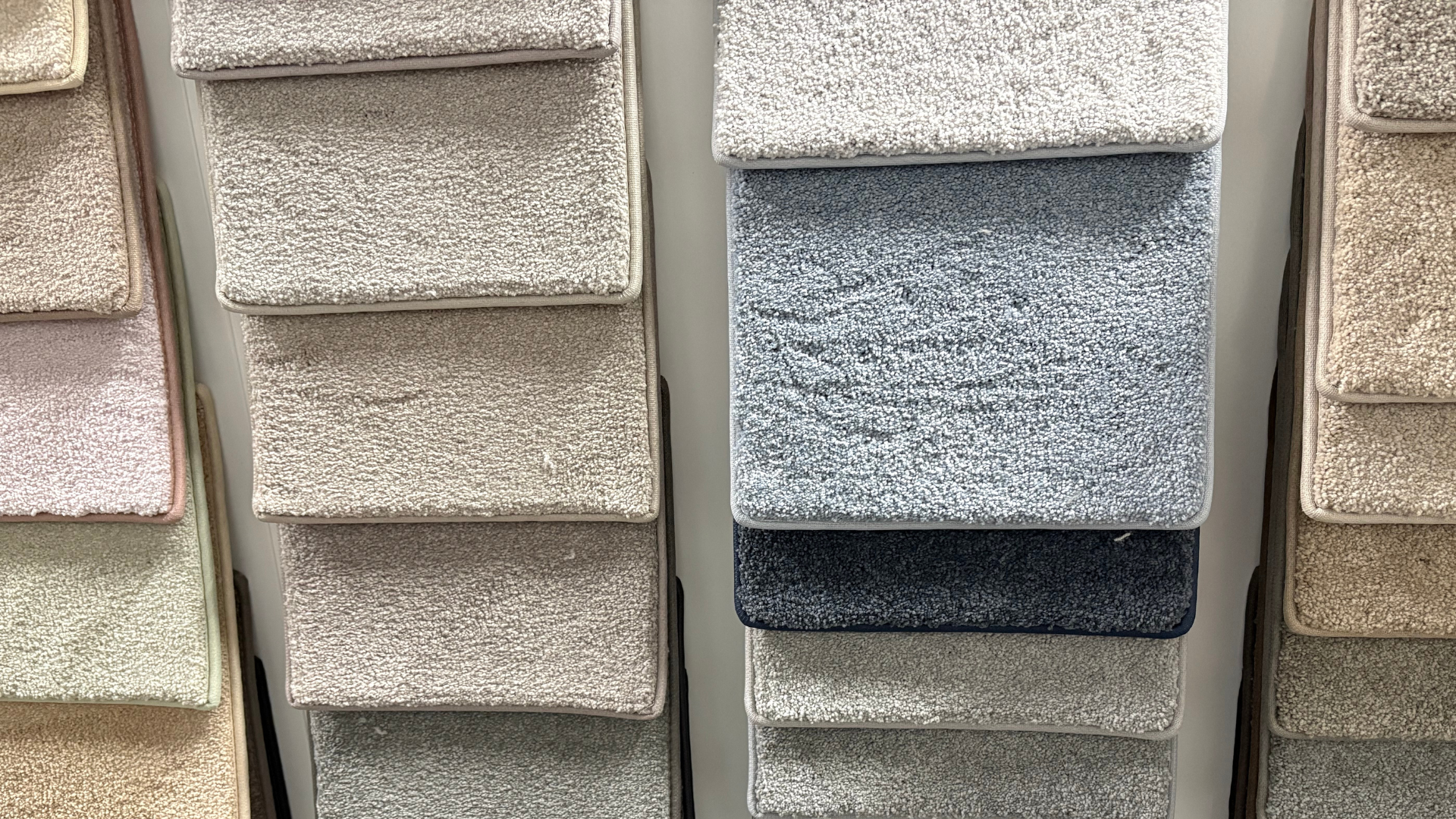 Swatches of various carpet samples arranged in vertical columns, showing different colors and textures.