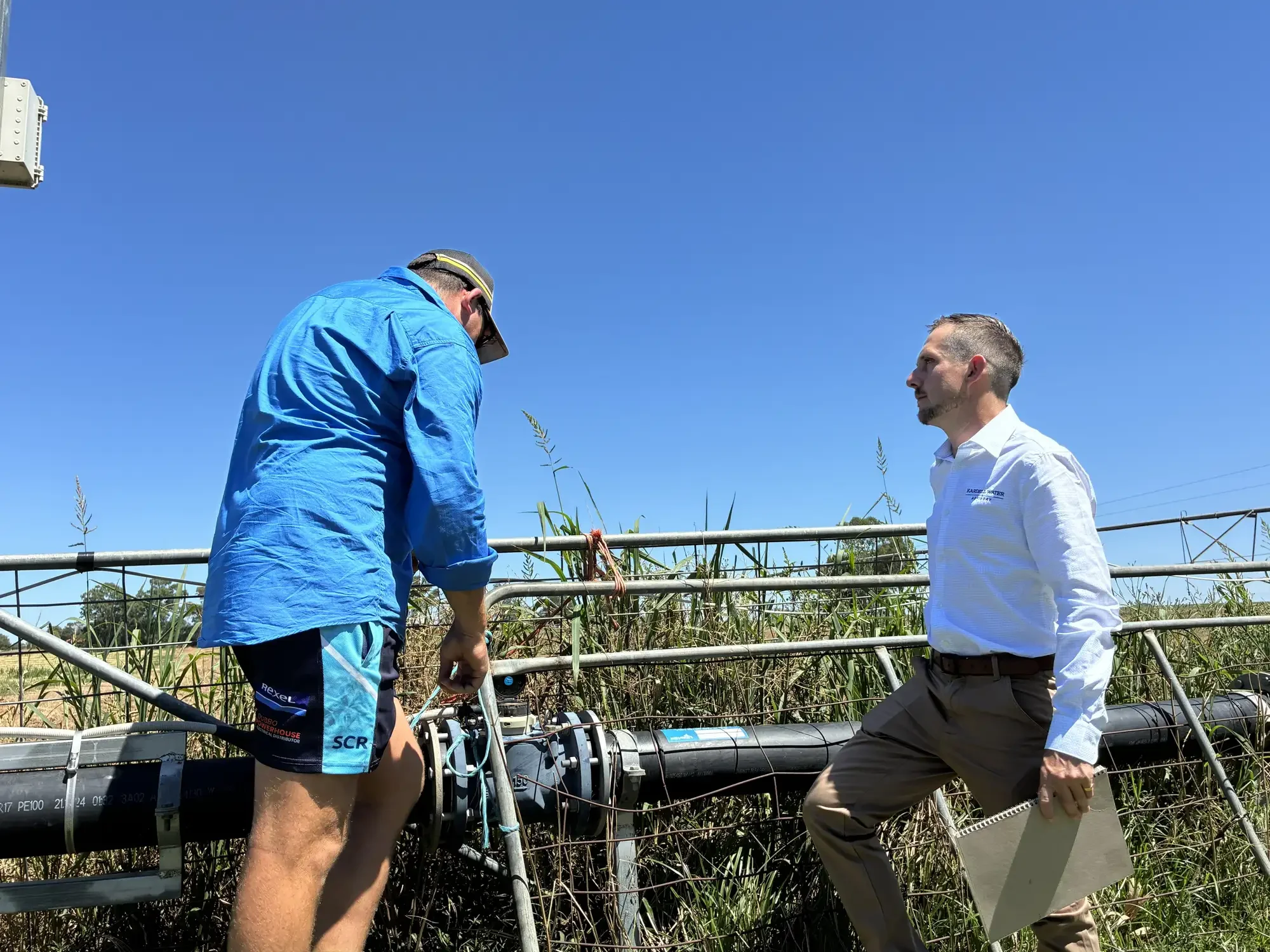 rob standing at a water meter with a client