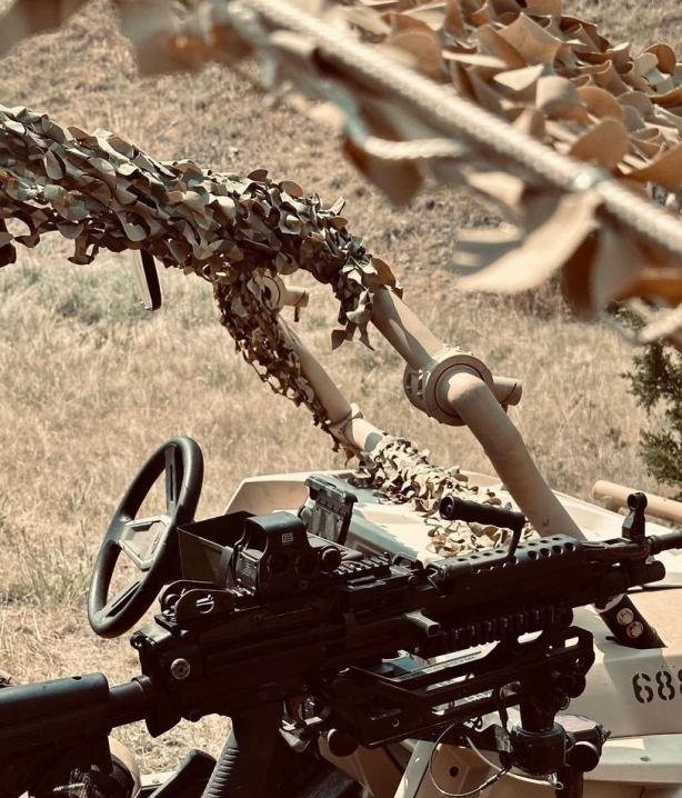 A lightweight weapon system on top of a combat vehicle.