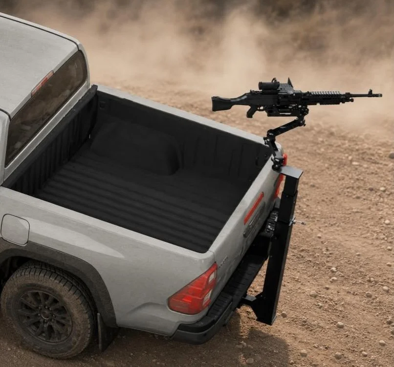 A pickup truck with a mounted gun in its bed, positioned in a dusty outdoor area.
