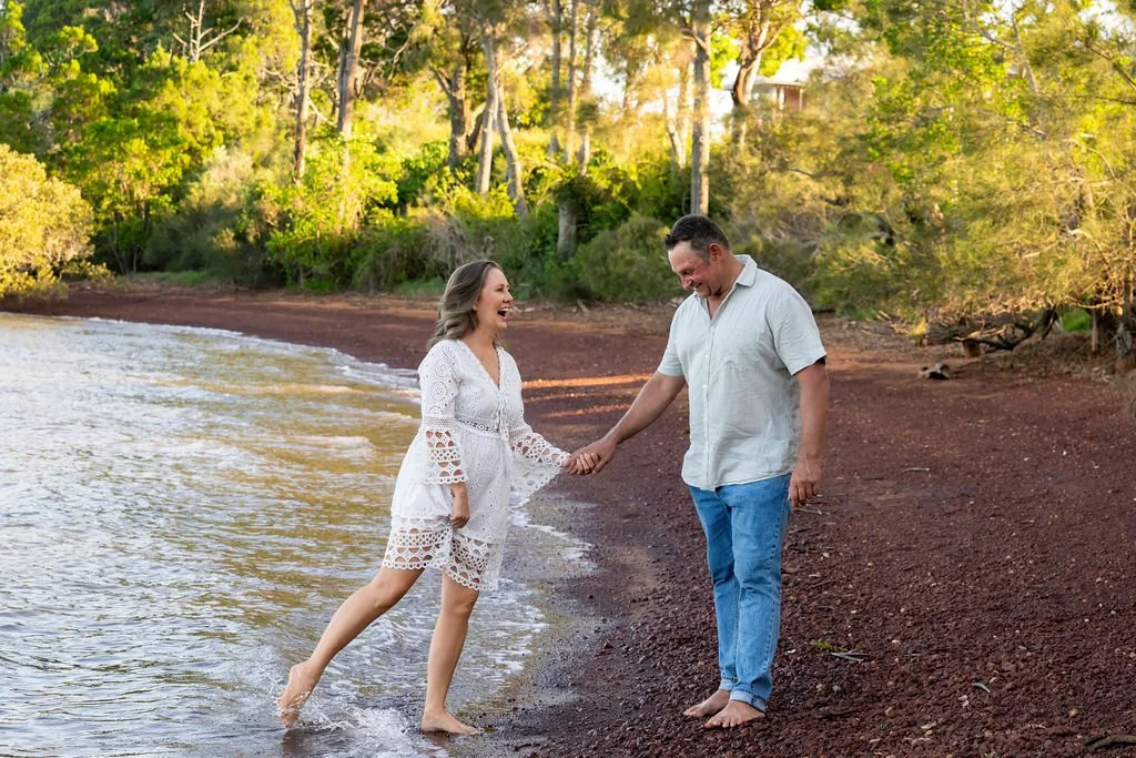 Renee and her husband holding hands on a beach.