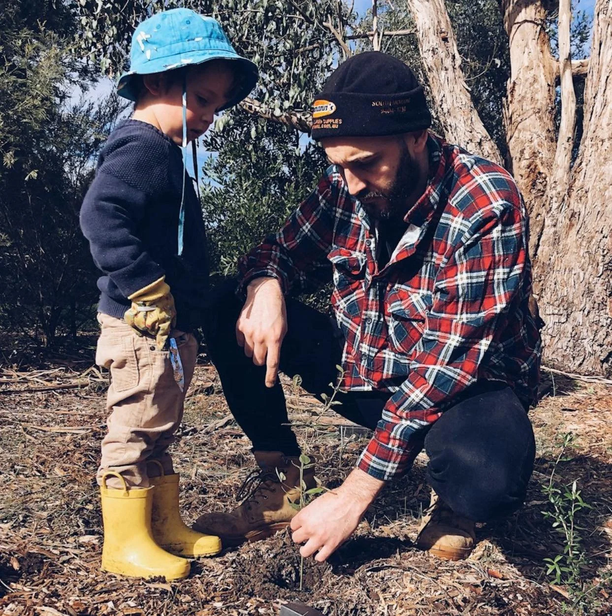 Anderson Outdoor Solutions team member showing his kid the art of landscaping.
