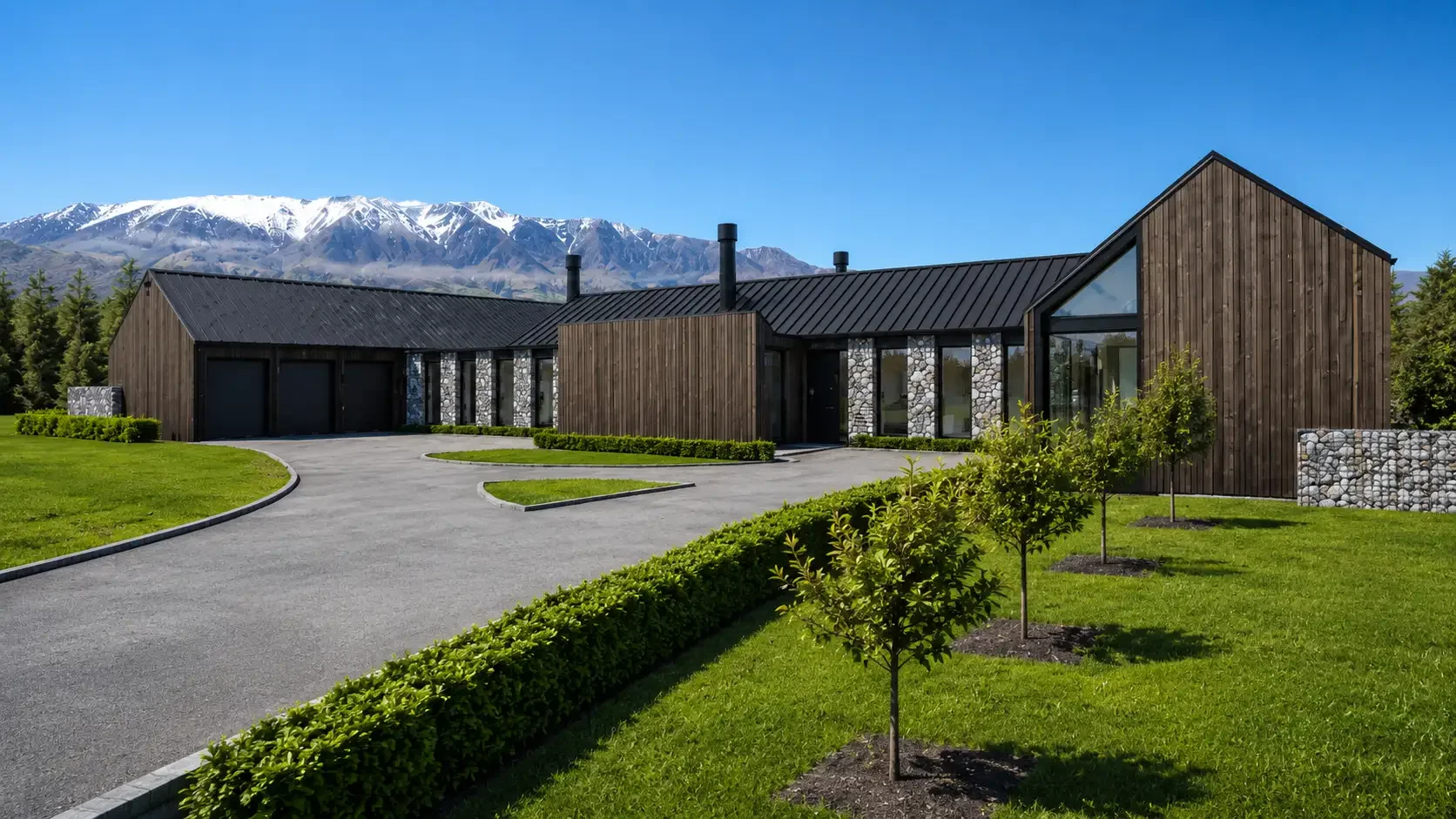 The entrance to Lot 9, Tui Estate, showcasing dark timber cladding, natural stone, and Southern Alps mountain views — a David Reid Homes luxury build in Rakaia Gorge, Canterbury.