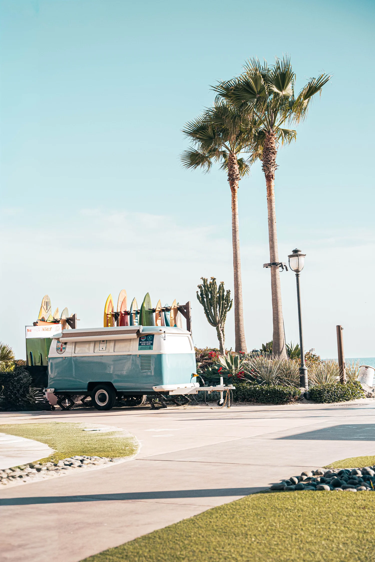 Vintage van with surfboards under palm trees