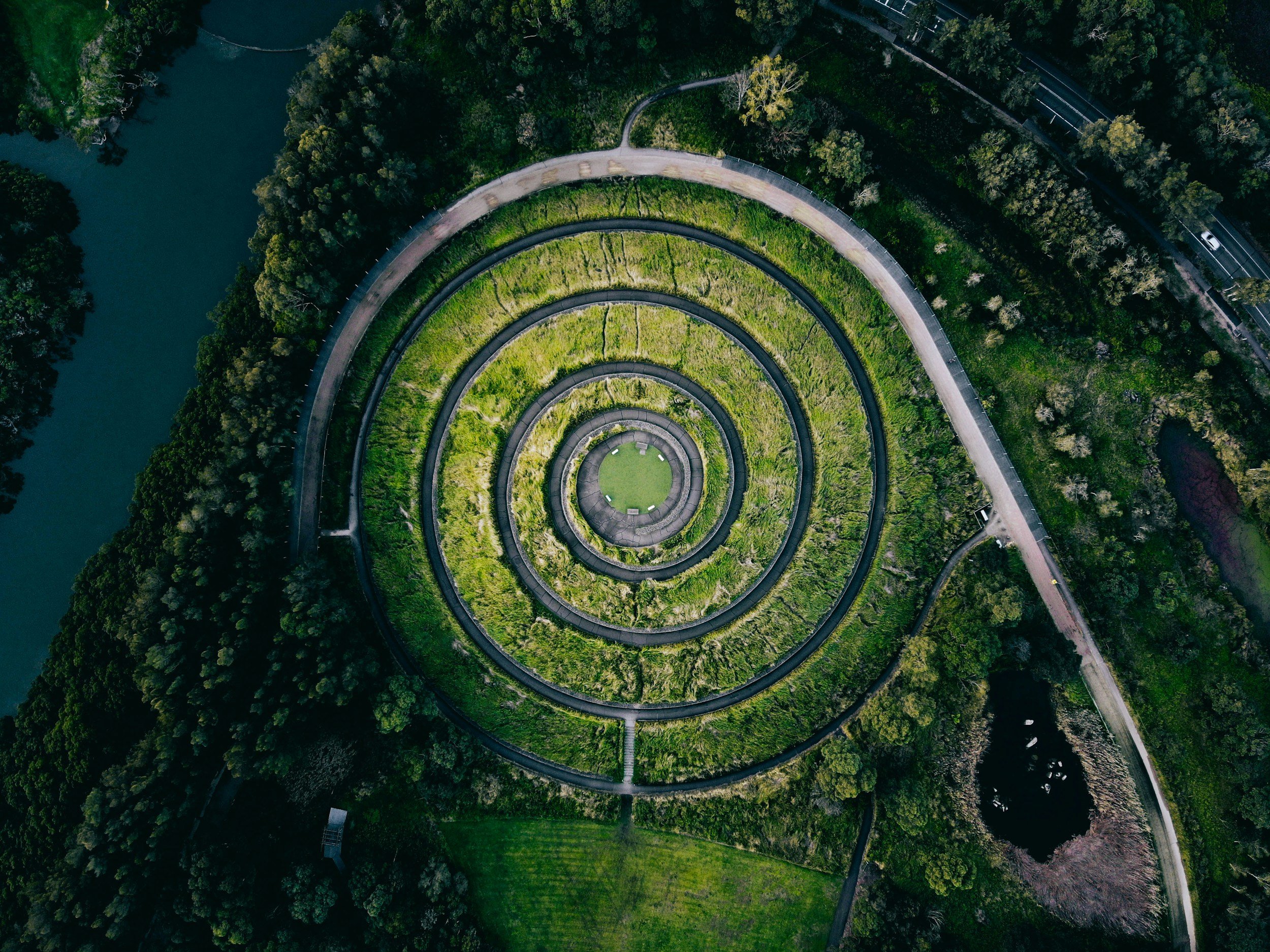 Arial photo of a circular labyrinth surrounded by a forest.