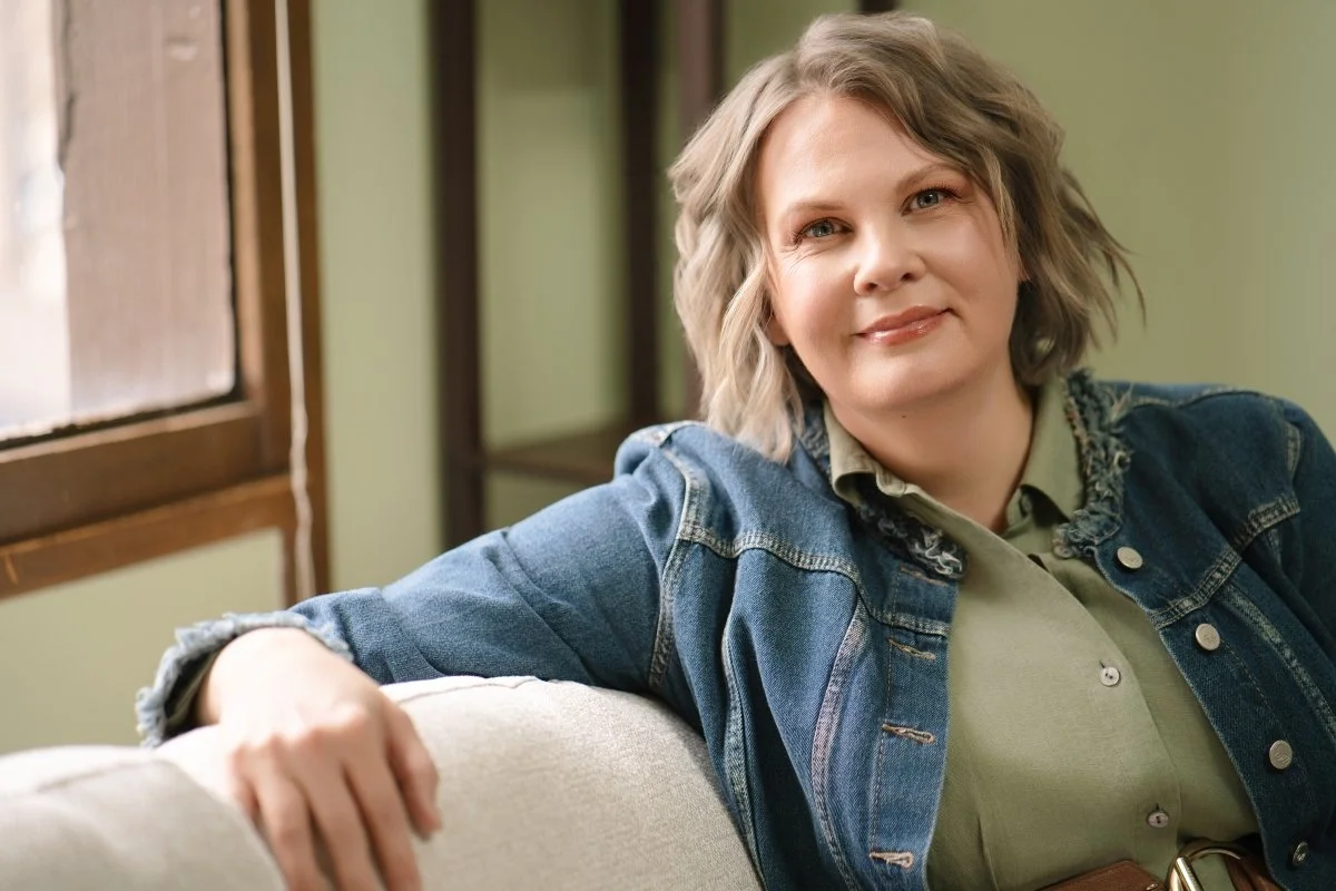 Professional photo of Megan Silberhorn, LPCC, counselor in Fort Collins, sitting on a couch "listening".