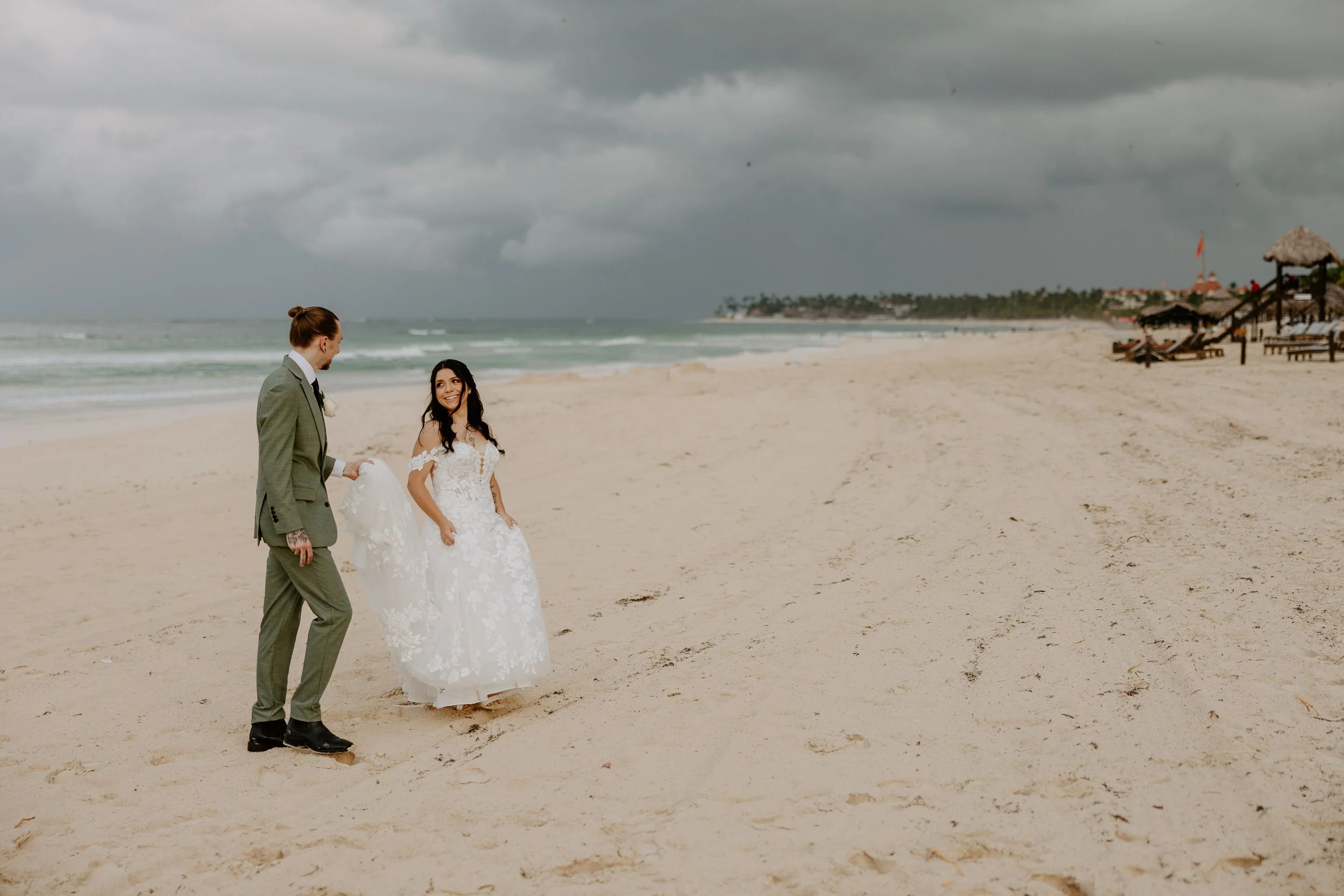 Couple walking on the beach after their wedding ceremony