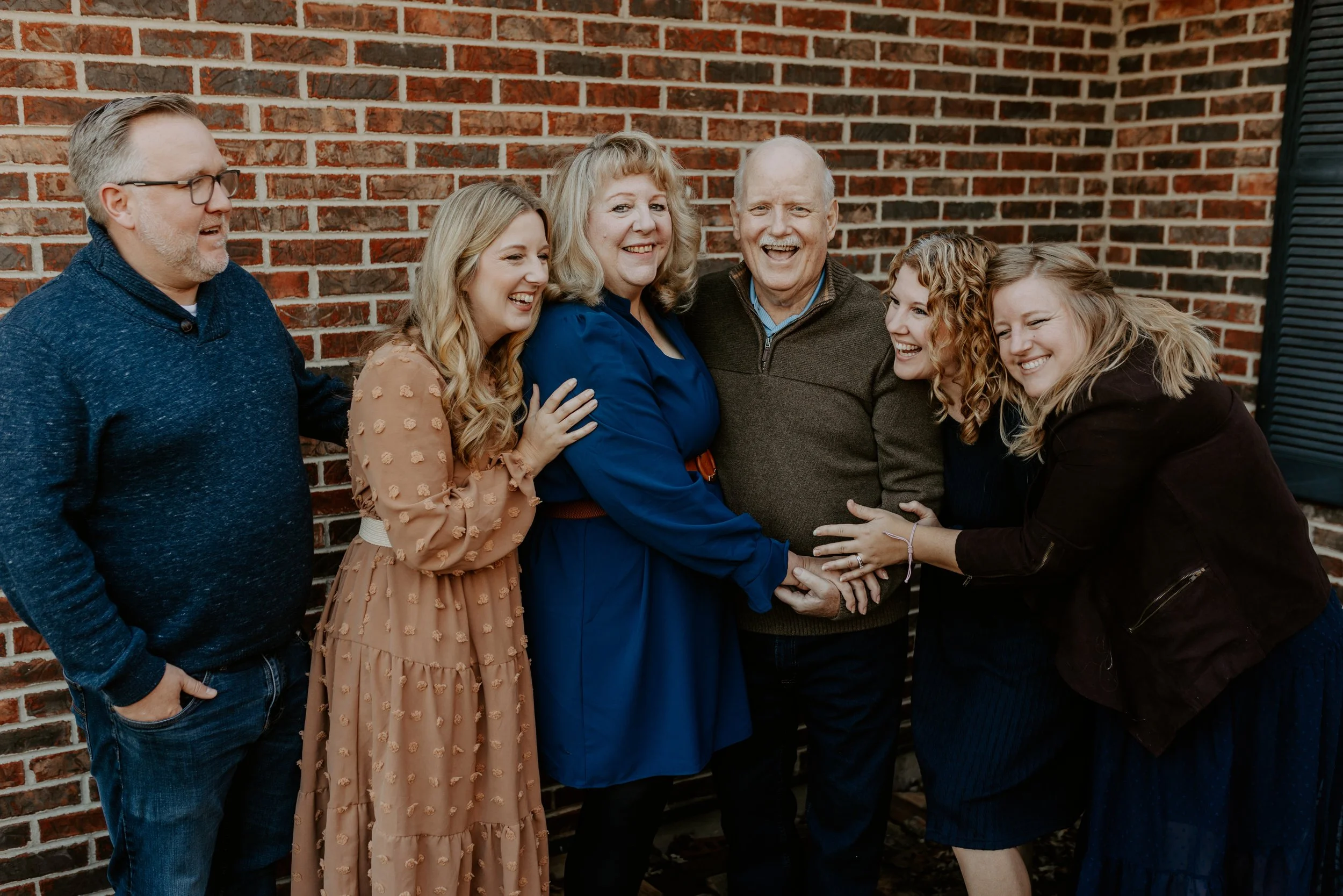 Kids gathered around their grandparents laughing and smiling