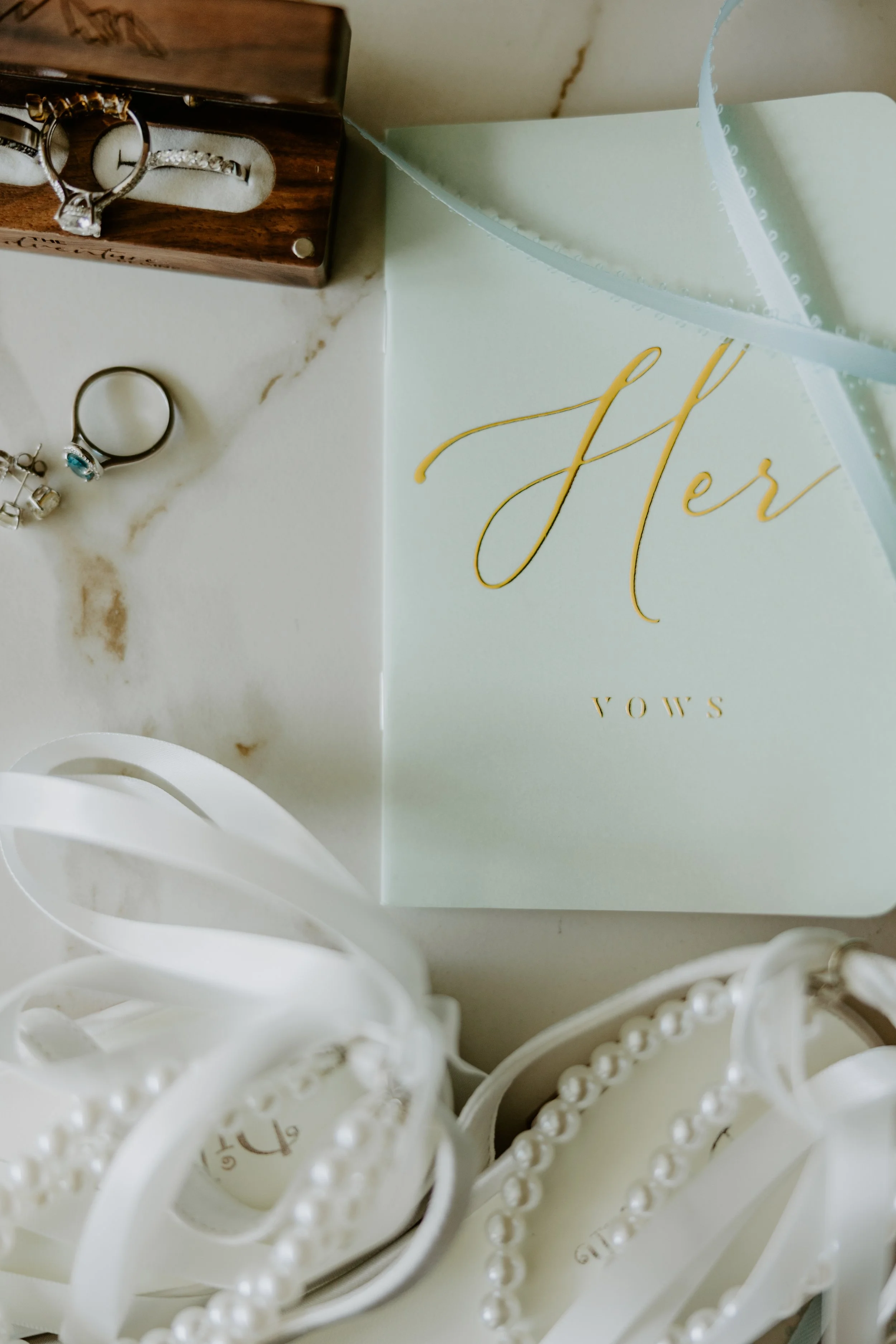Flat lay of wedding details and a vow book