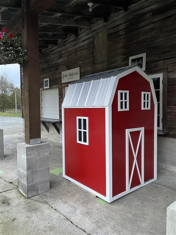 A red and white mini barn for off season frozen sales alongside our classic barn.