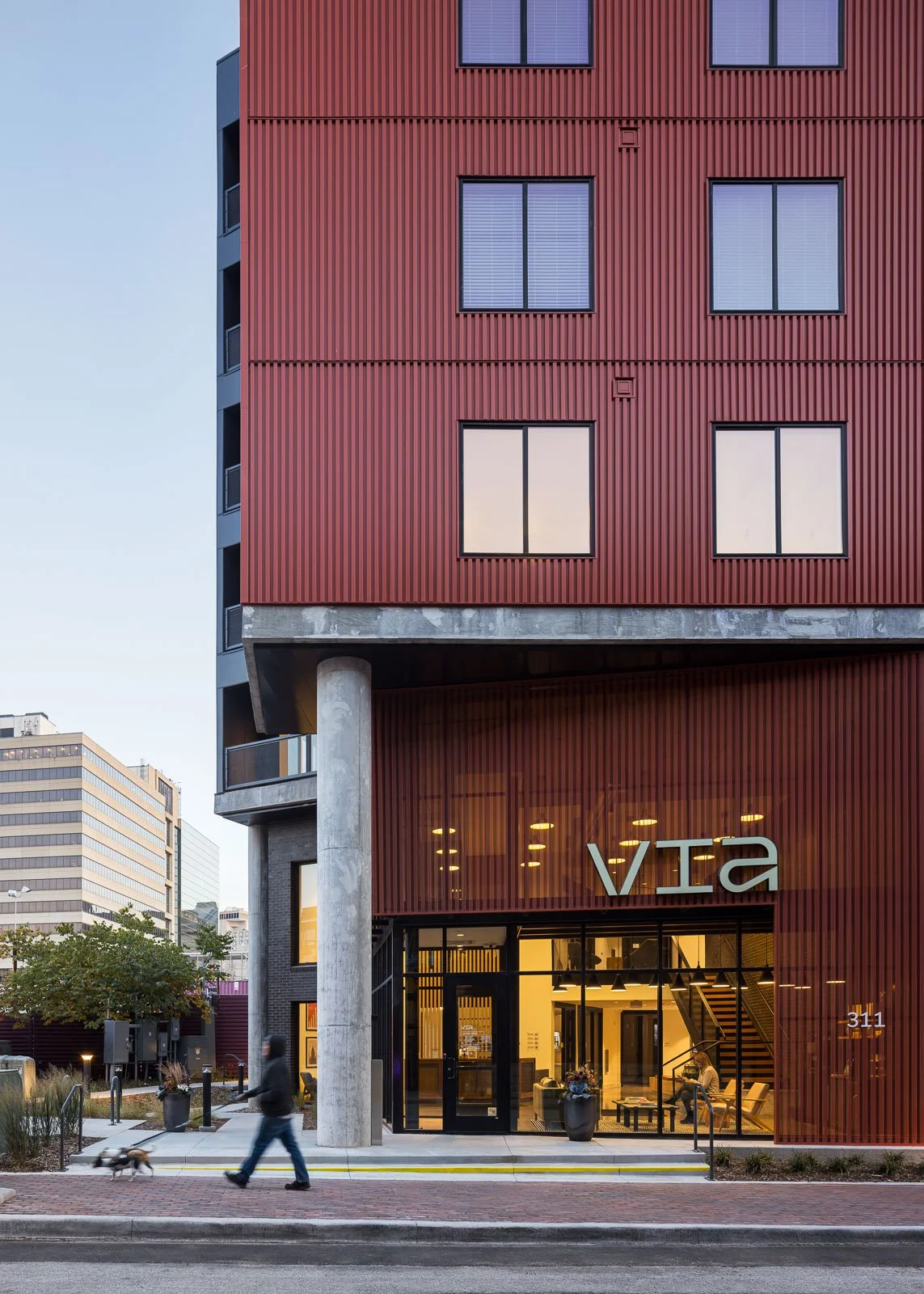 Side exterior perspective of Tracks commercial architecture showcasing materiality and structure.