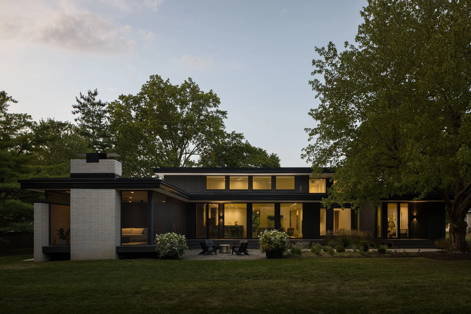 Exterior perspective of Prairie Light home with light-filled façade and surrounding landscape