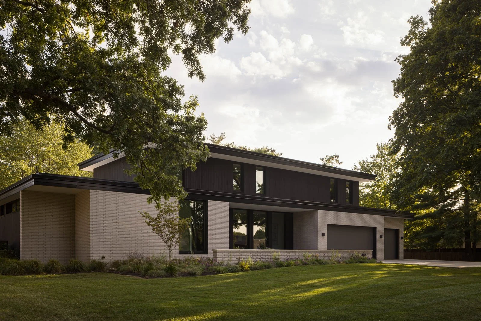 Side exterior view of Prairie Light home highlighting architectural lines and materiality