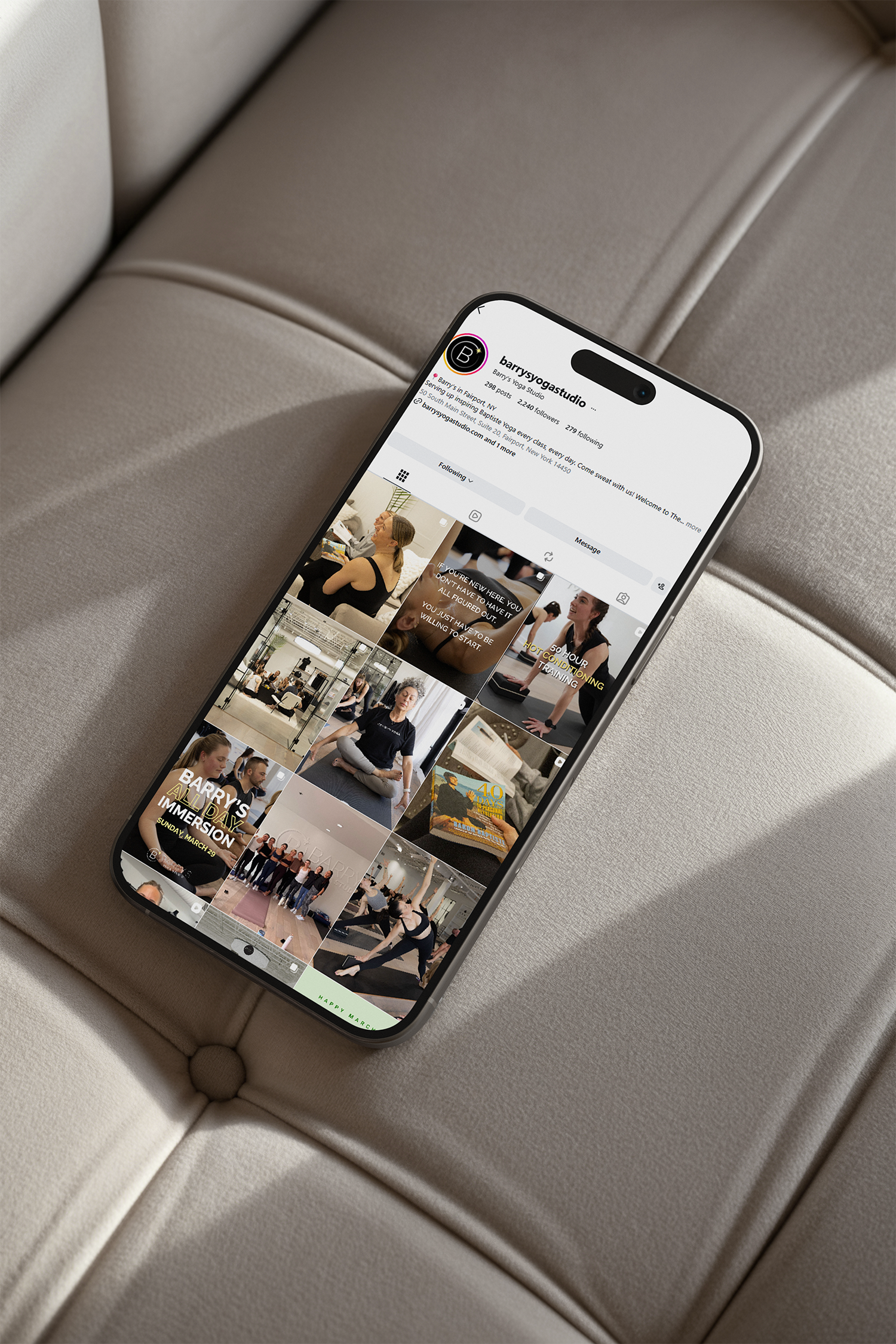 Smartphone displaying an Instagram profile page on a beige cushioned surface.