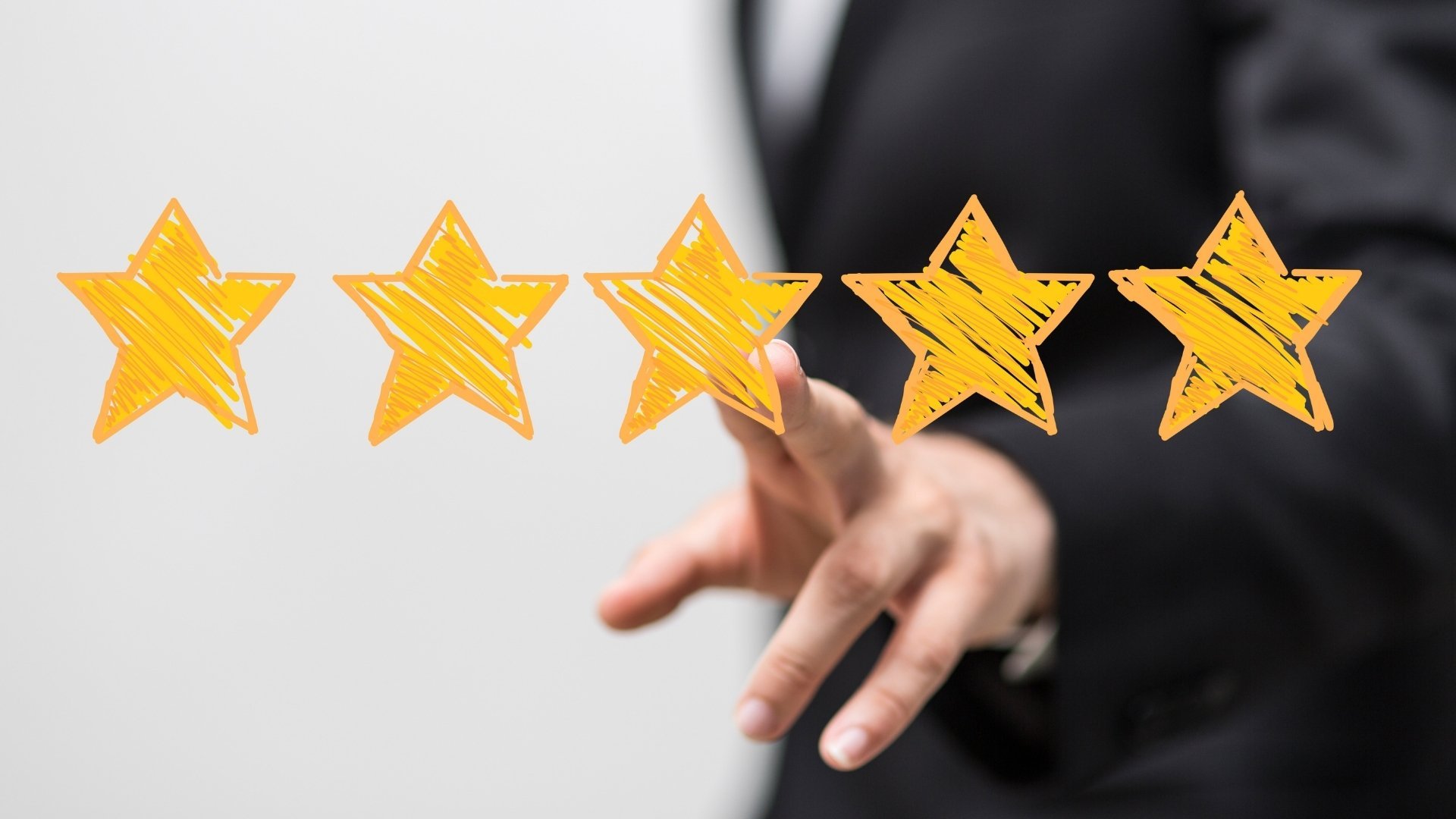 Hand selecting a five-star rating against a blurred business background