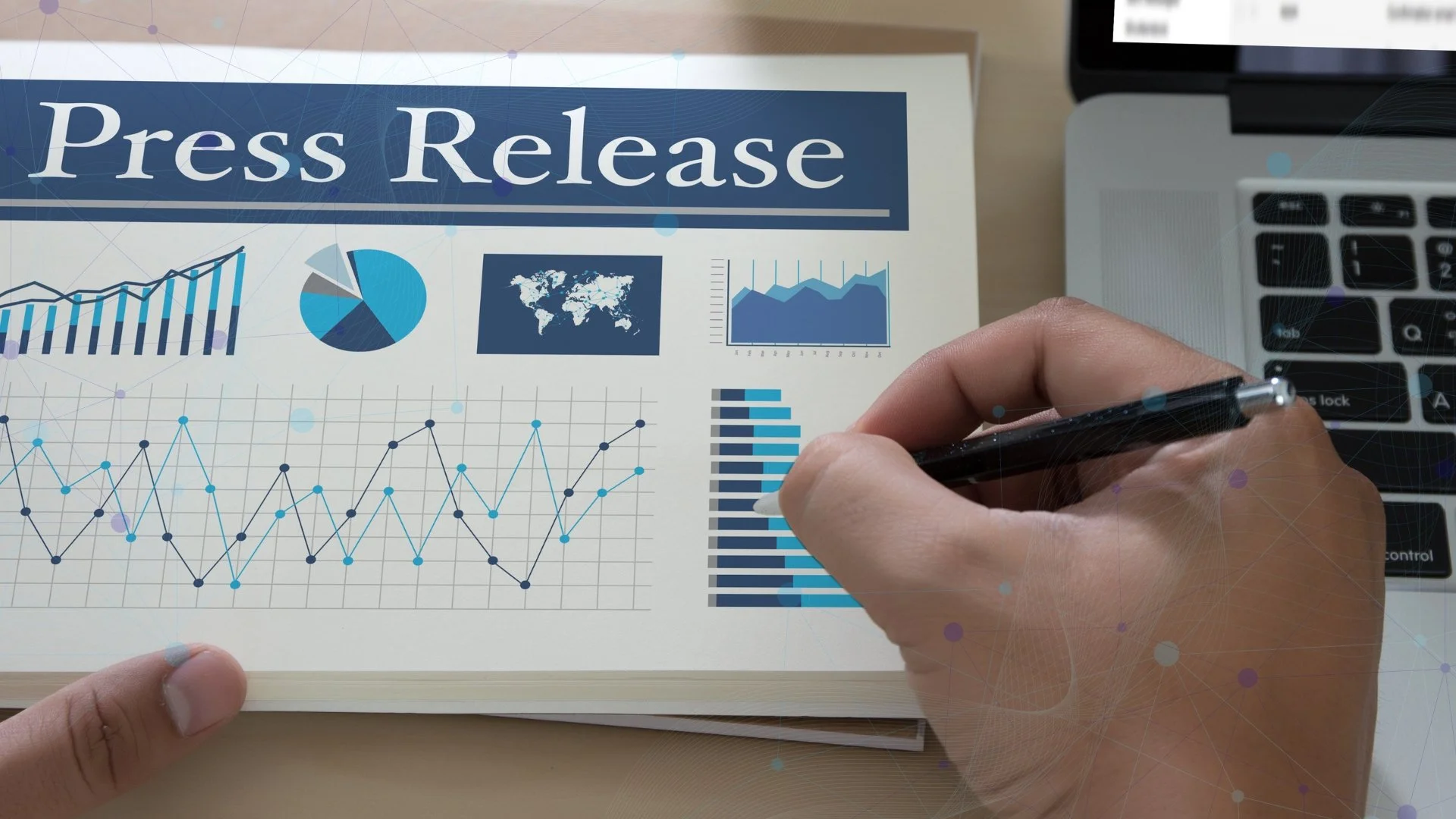 Person reviewing a press release report with charts beside a laptop and digital network graphics.