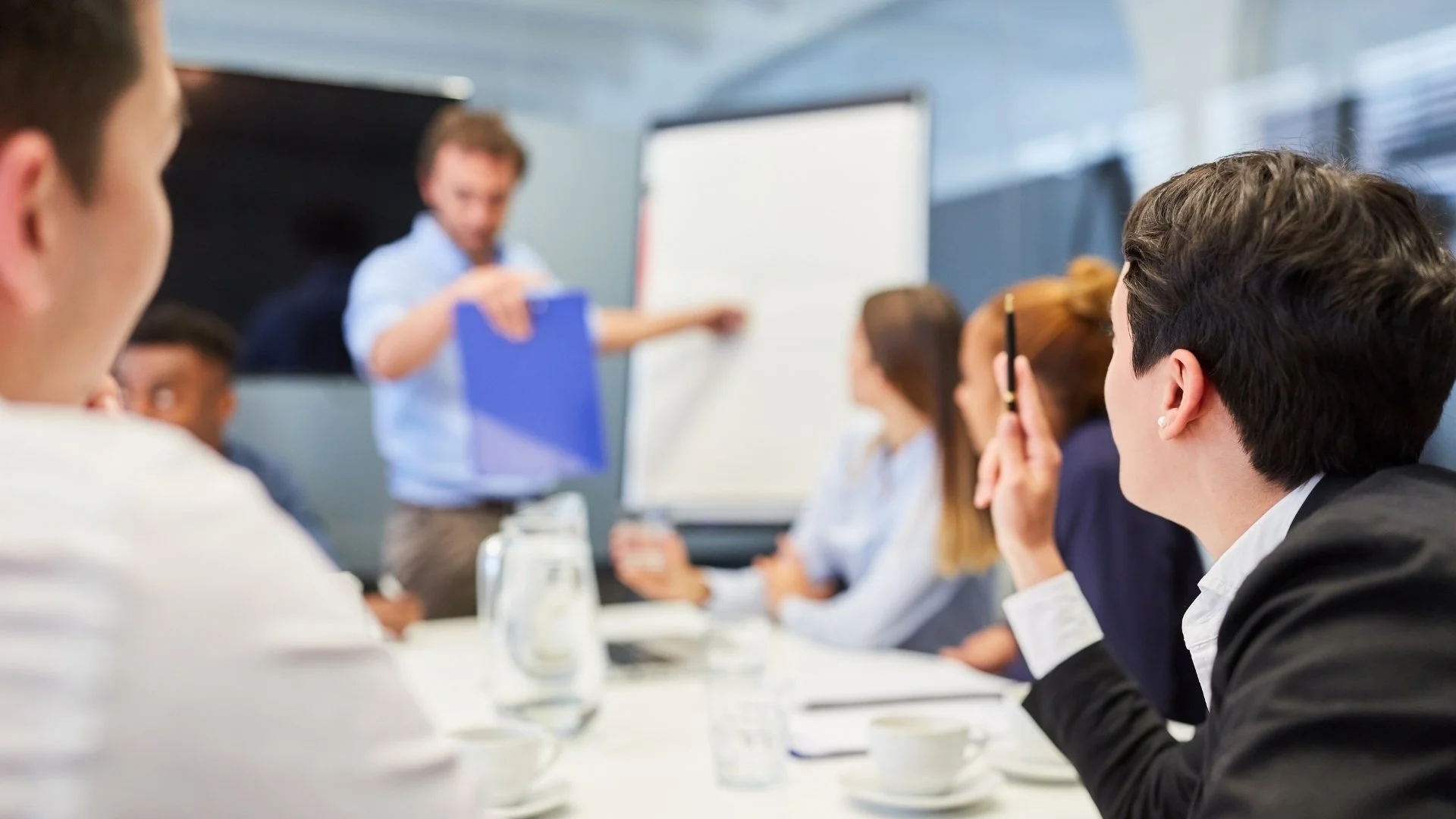 Communications team attending a workplace training session led by a presenter.