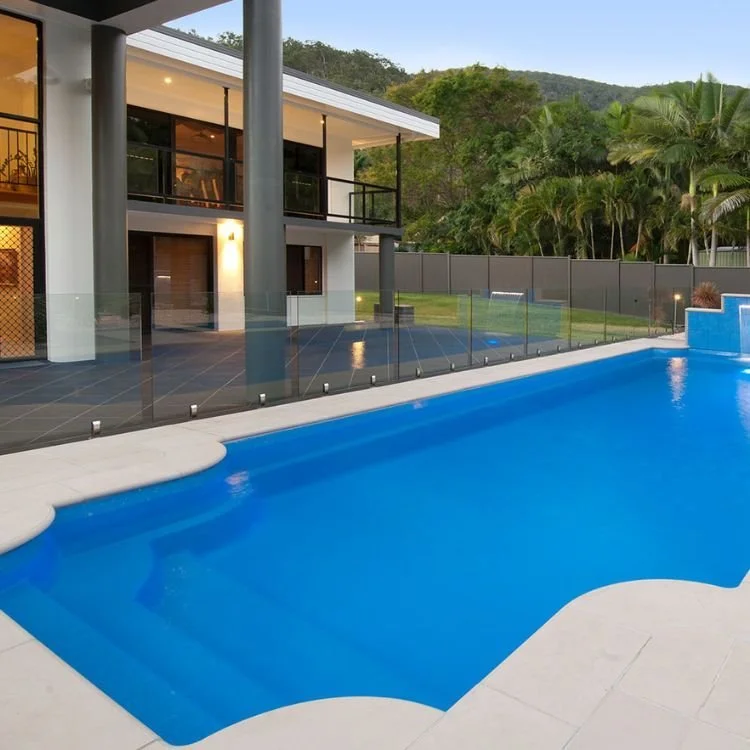 Freedom Pools Corinthian 11.6m fibreglass pool with glass fencing and luxury home - available through Plungeit Pools Queensland