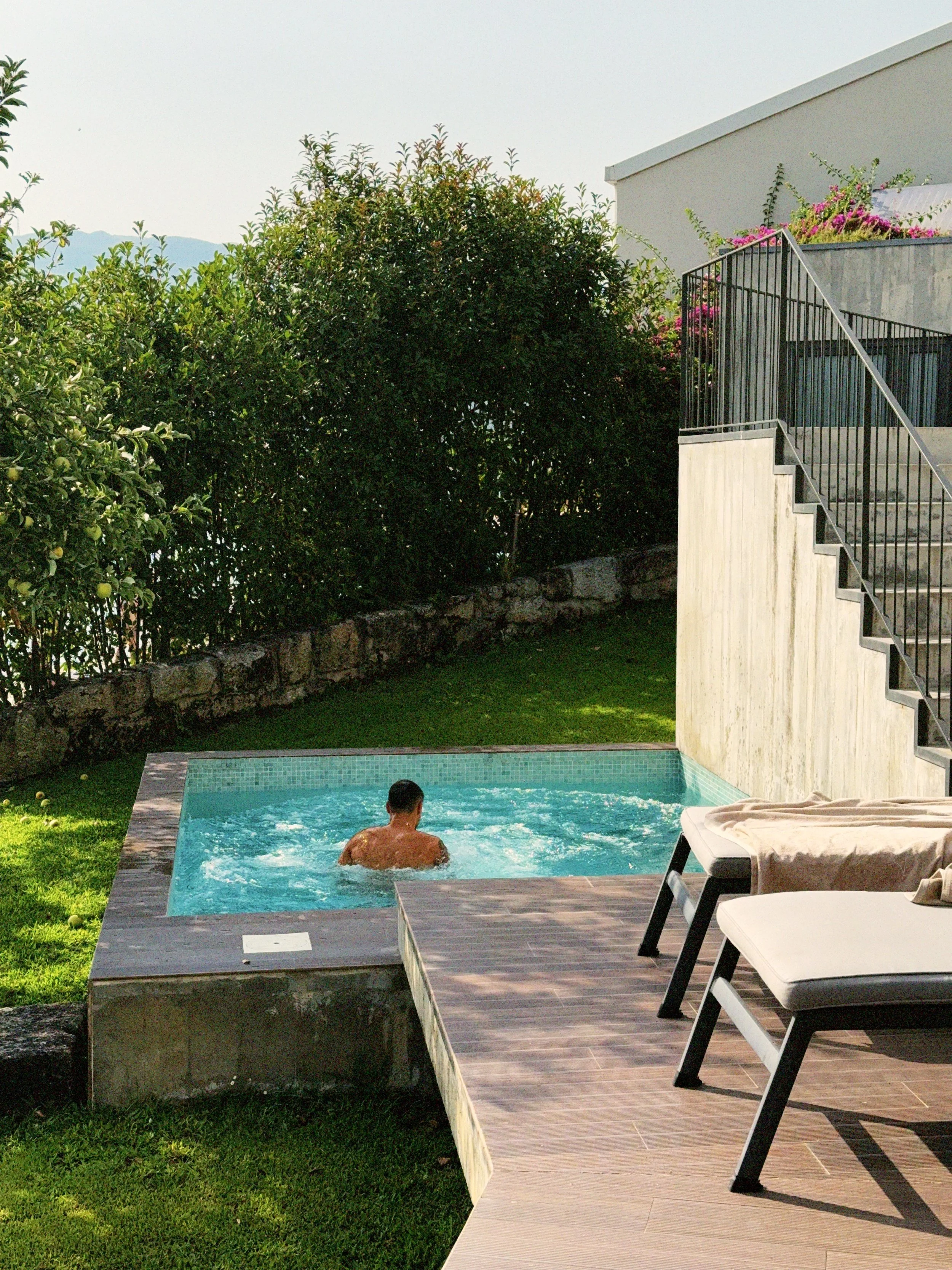 Compact concrete plunge pool in a small backyard with timber decking - Plungeit Pools Queensland
