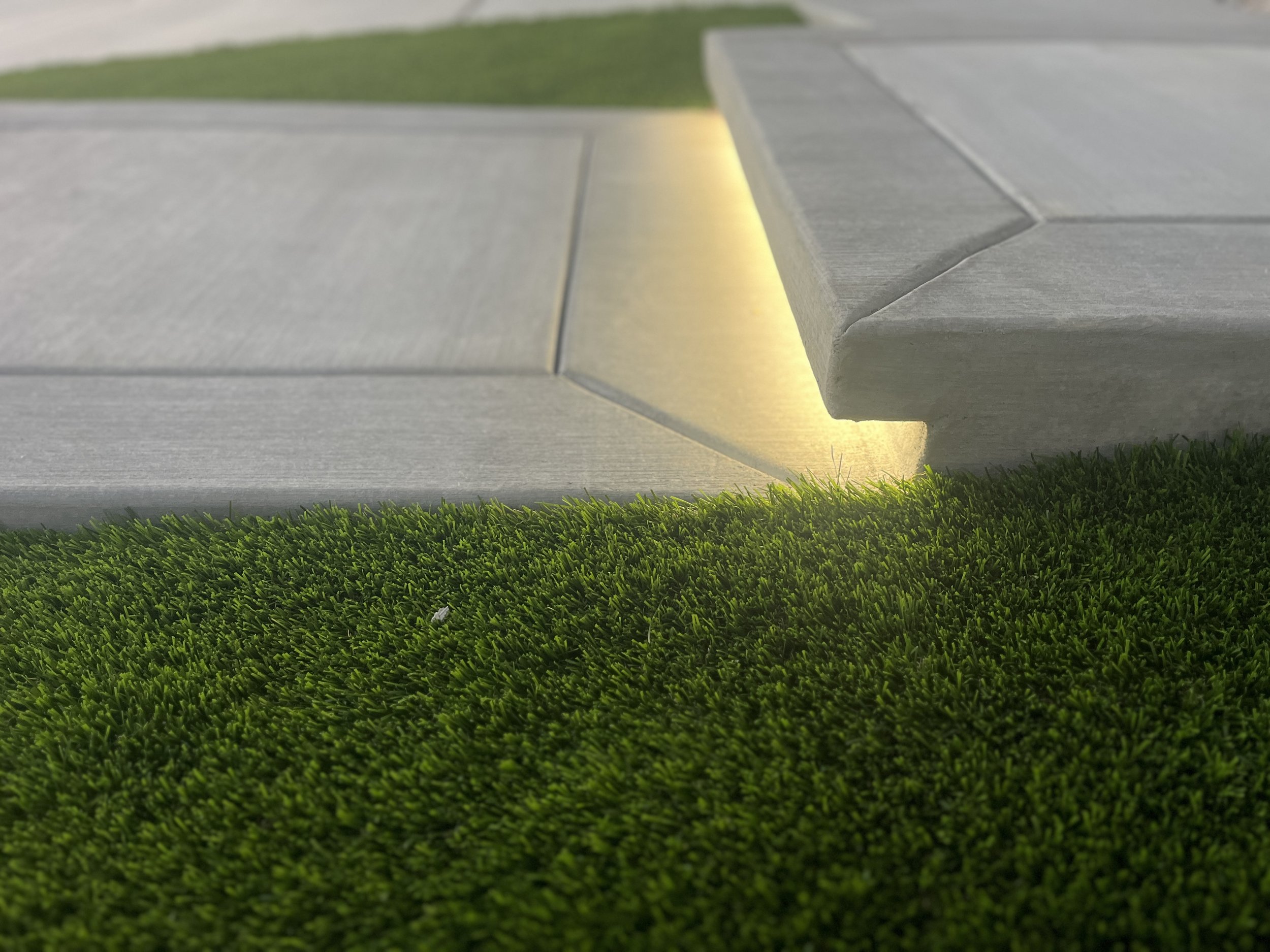 Precision concrete flatwork with clean joints and smooth finish paired with artificial turf in Murrieta, CA.