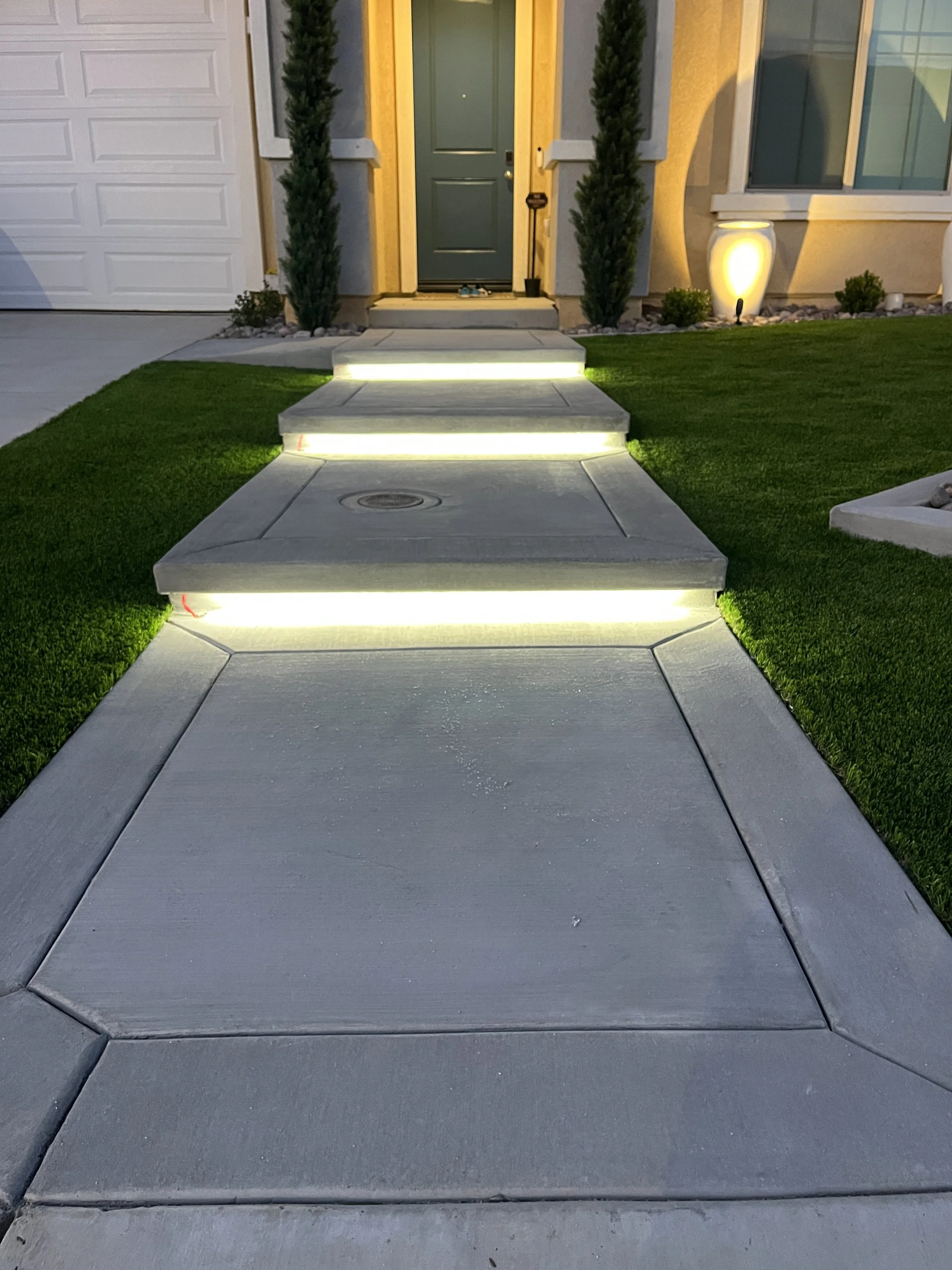 Residential backyard project completed in Menifee, CA, including stamped color concrete patio installation and artificial turf landscaping for improved curb appeal and functionality.