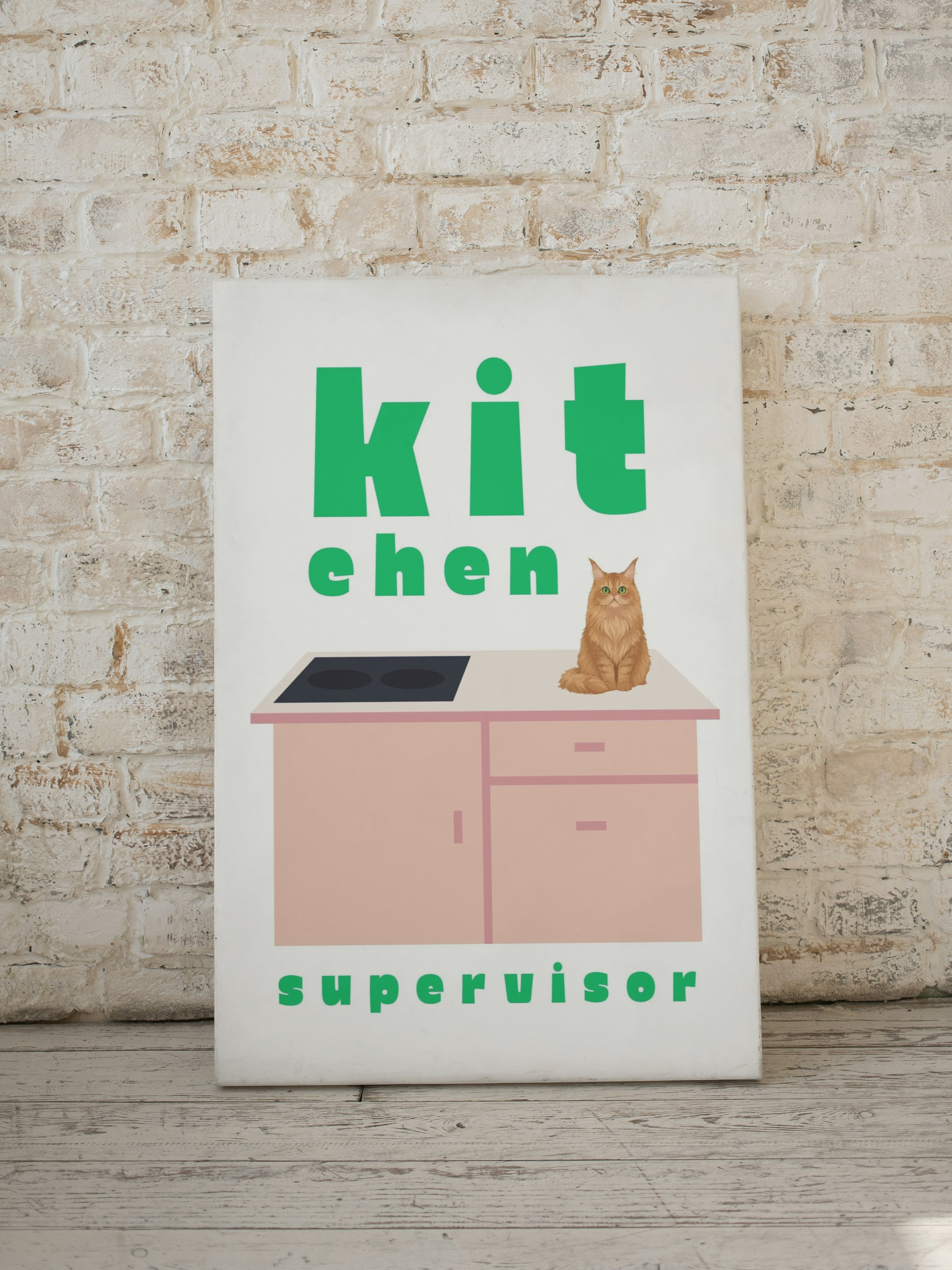Decorative sign with the words 'kitchen' and 'supervisor', featuring a cartoon kitchen counter with a stovetop and a sitting cat.