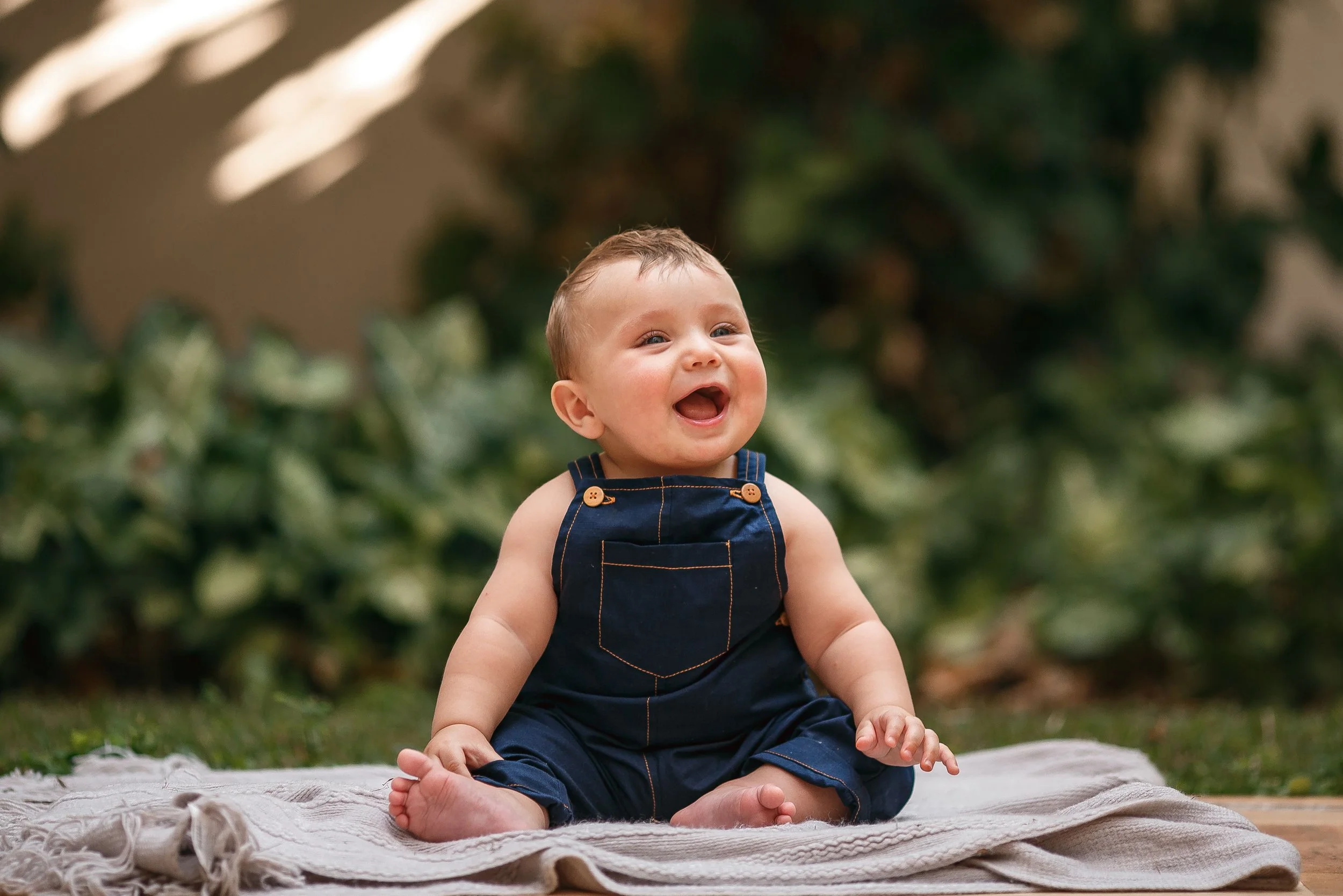 Smiling baby sitting outdoors