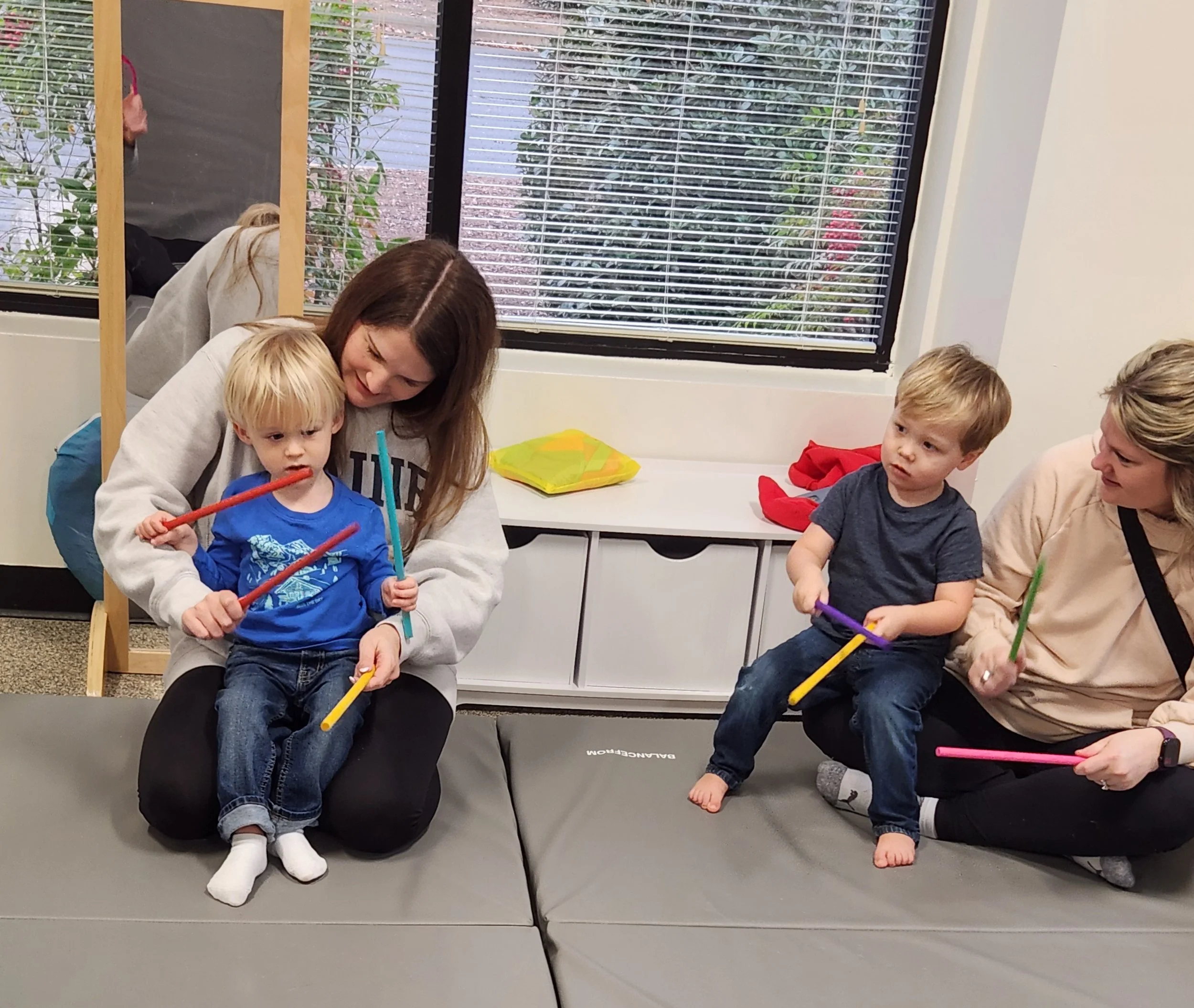 kids playing with music sticks