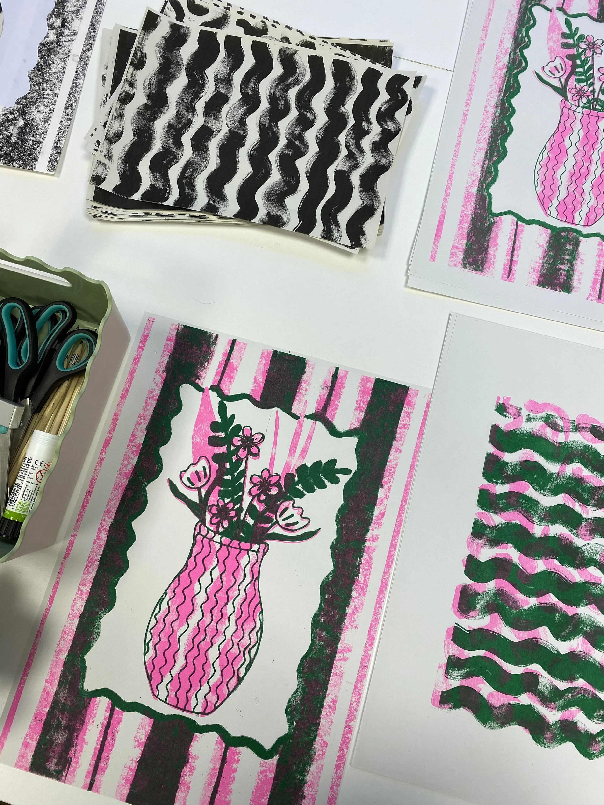 Riso print of floral illustrations in green and pink, featuring a vased flower arrangement surrounded by a pink striped background and a green scalloped border.