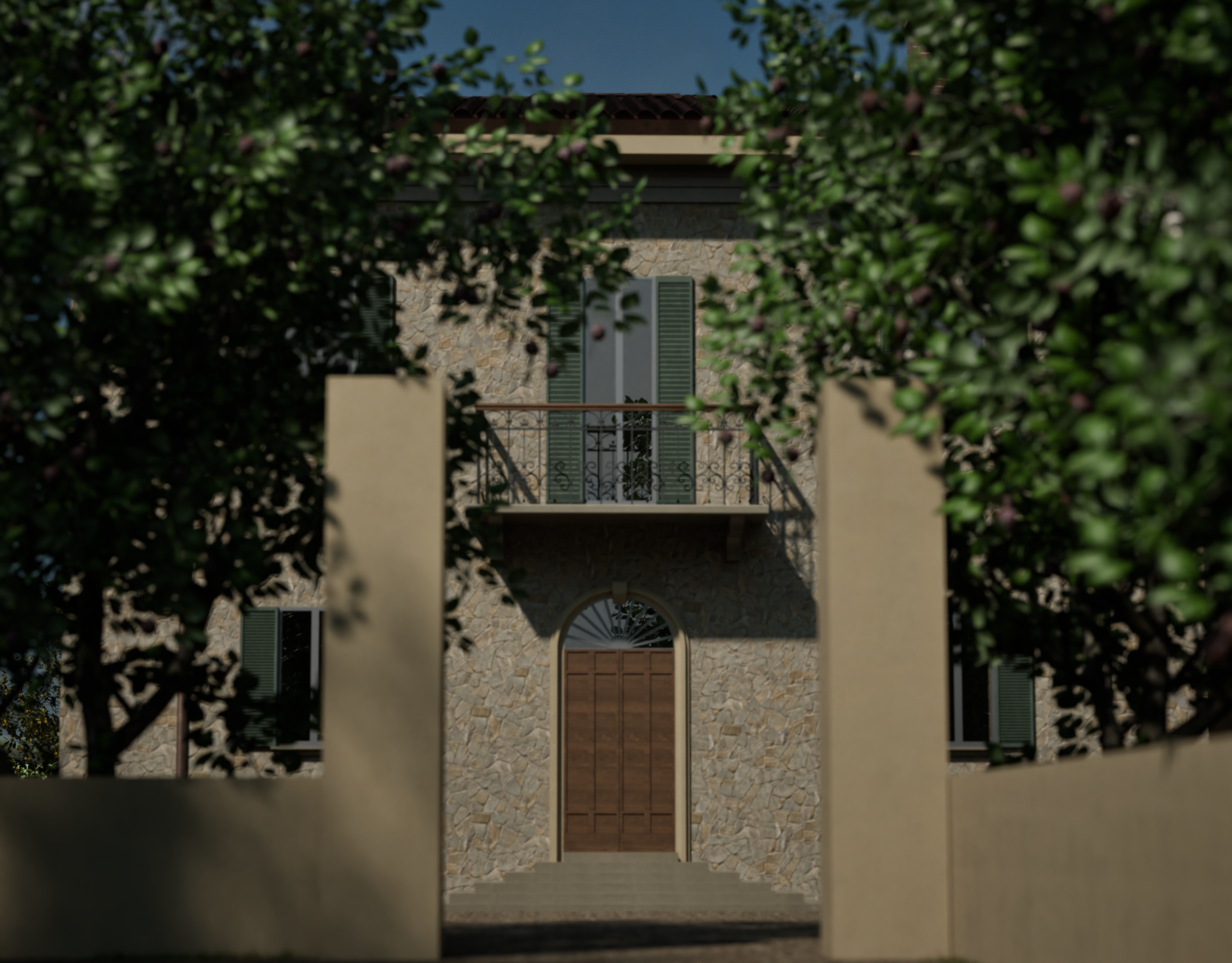 Stone house with green shutters and a balcony, viewed through a white gate with leafy trees in the foreground.